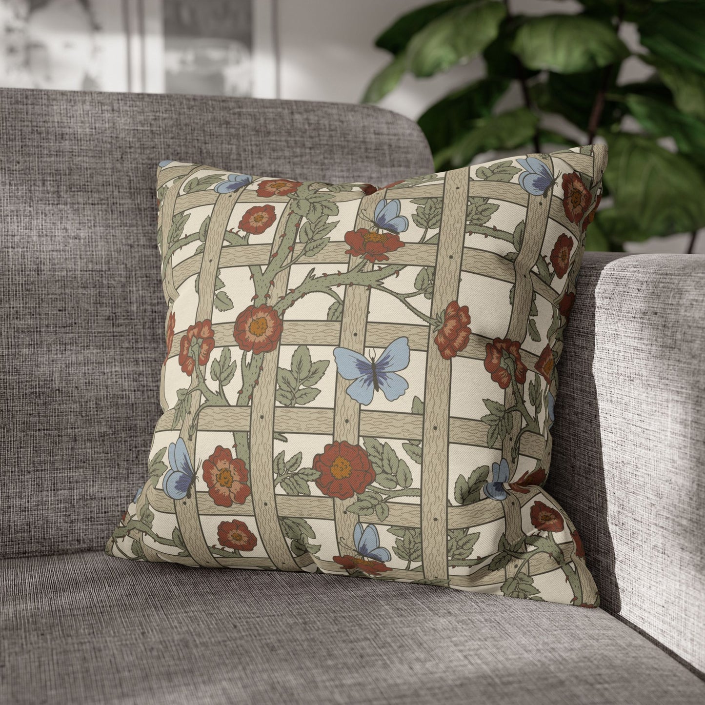 Decorative pillow with floral and butterfly pattern on a gray sofa