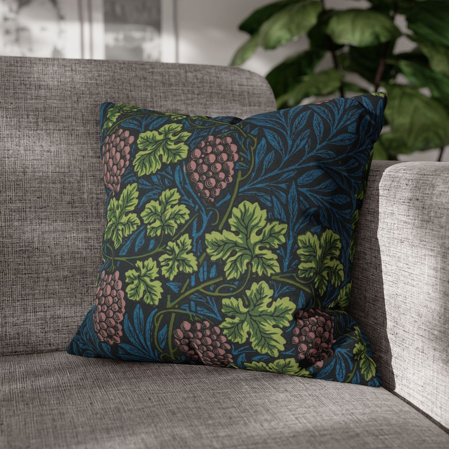 Decorative pillow with leaf pattern on a gray sofa