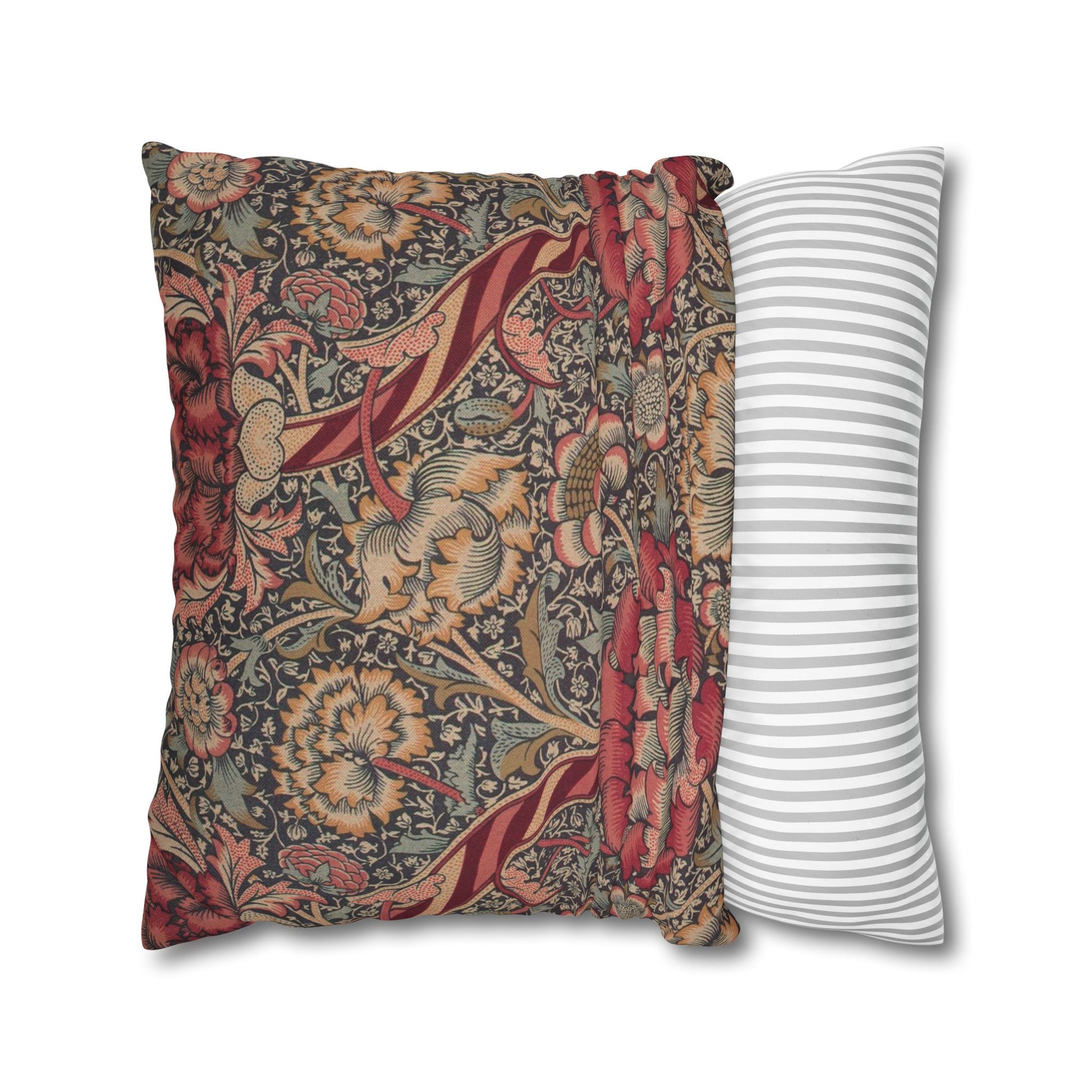 Two pillows, one with floral pattern and one with stripes, on a white background