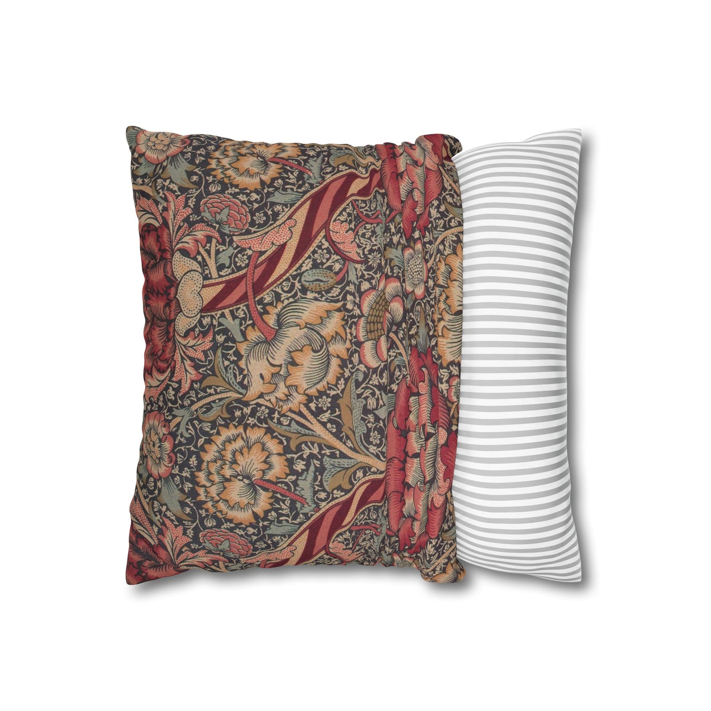 Decorative pillow with floral pattern next to a striped pillow on a white background