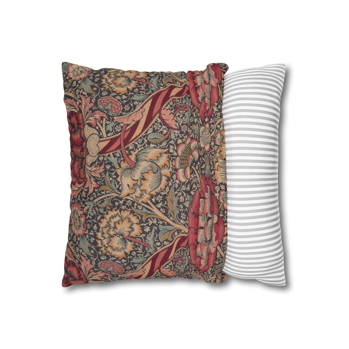 Decorative pillow with floral pattern next to a striped pillow on a white background