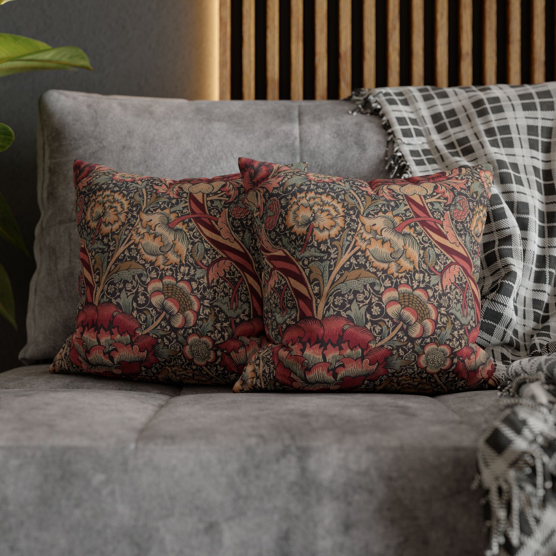 Decorative pillows with floral patterns on a gray sofa.