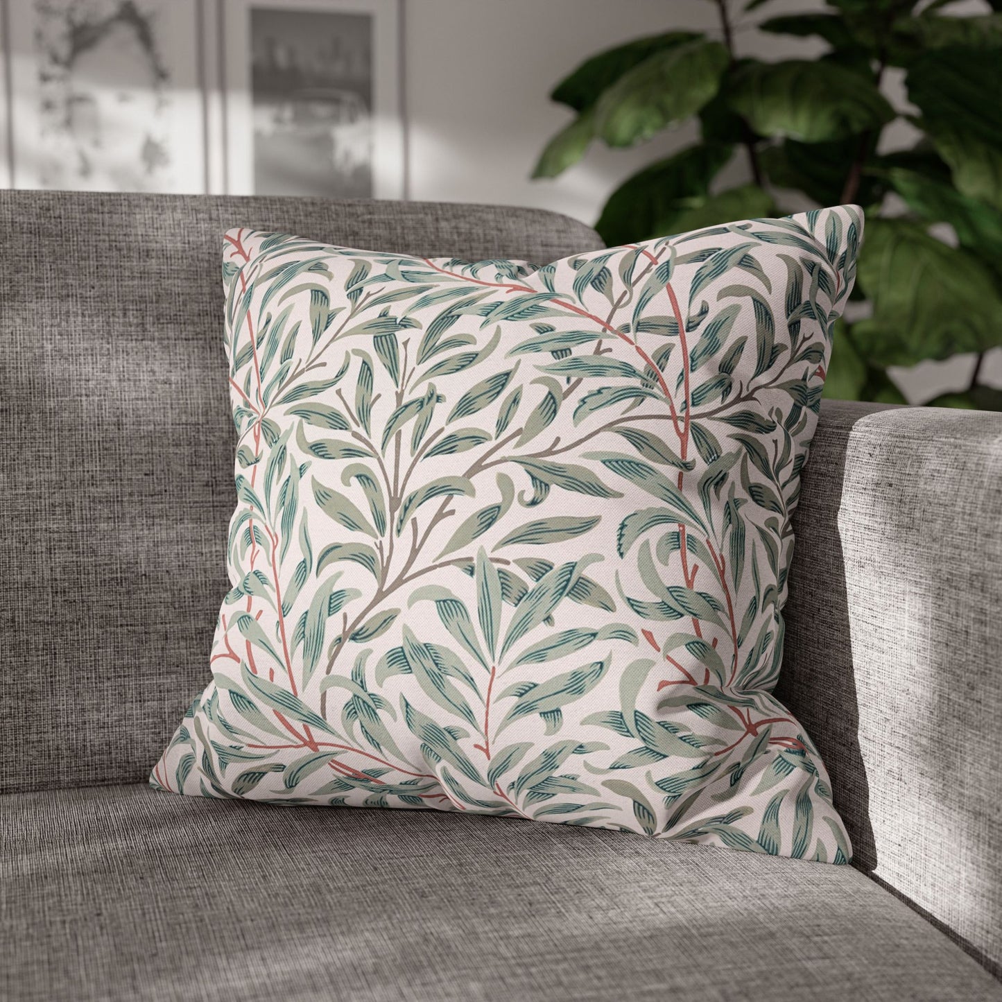 Decorative pillow with leaf pattern on a gray sofa