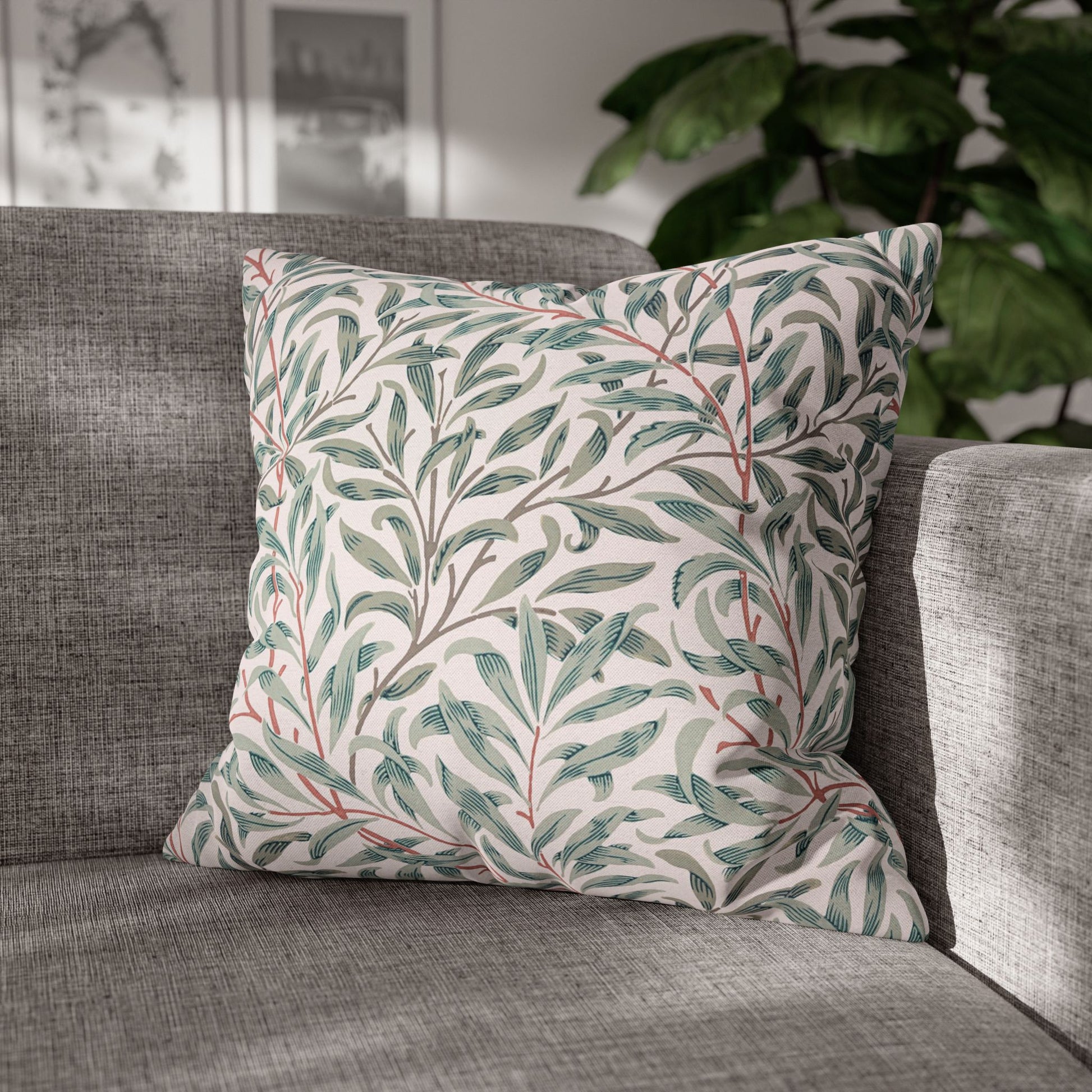 Decorative pillow with leaf pattern on a gray sofa