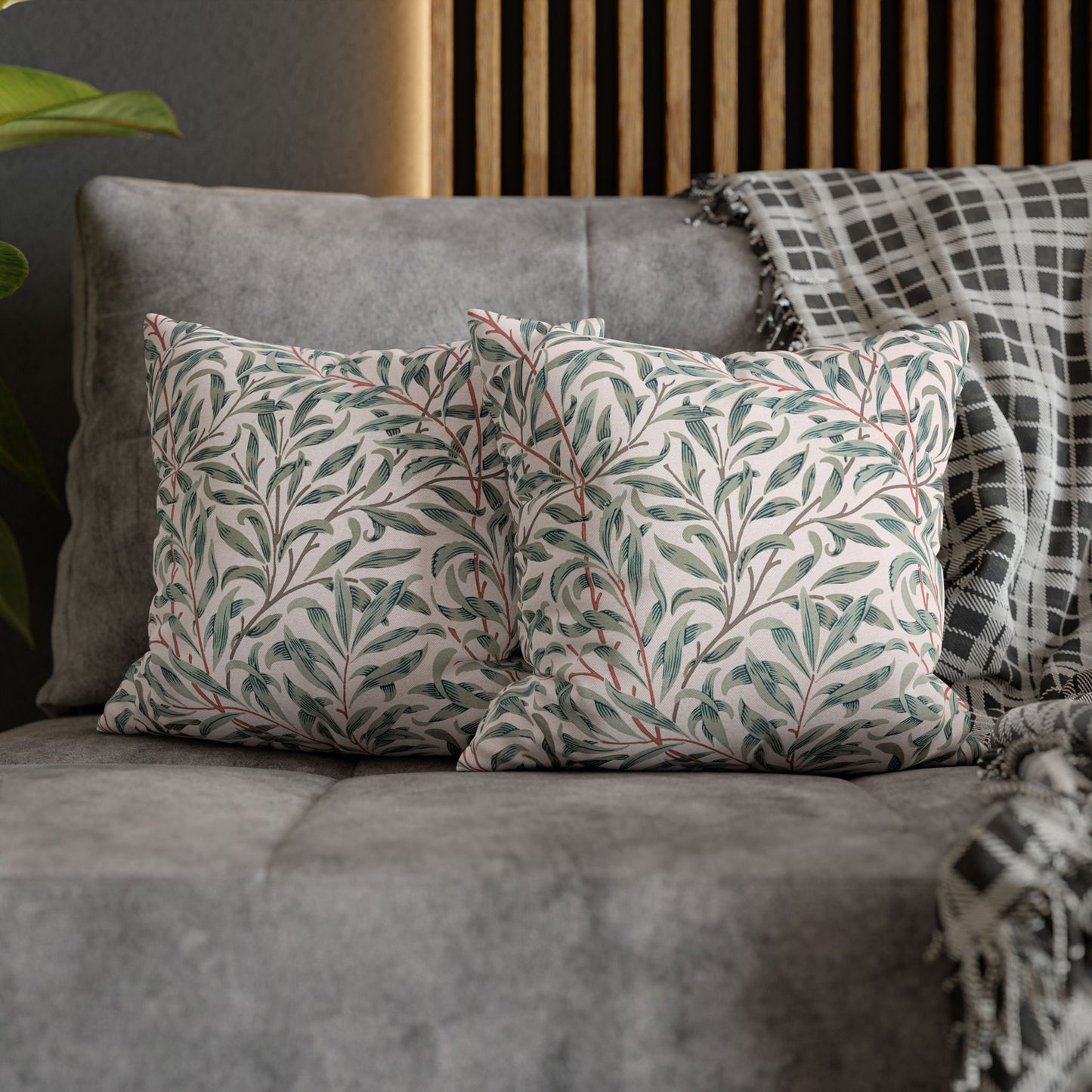 Decorative pillows with leaf pattern on a gray sofa