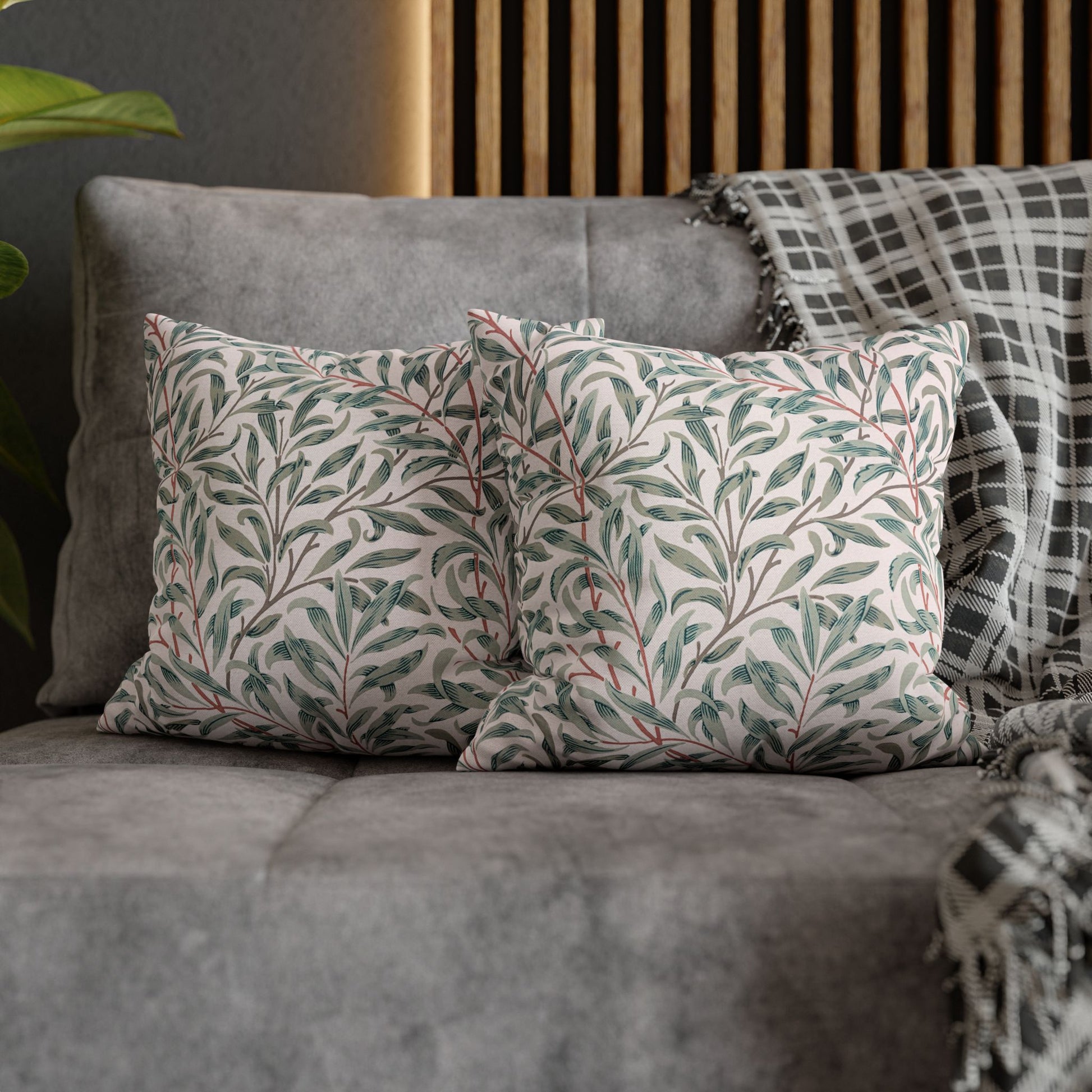 Decorative pillows with leaf pattern on a gray sofa