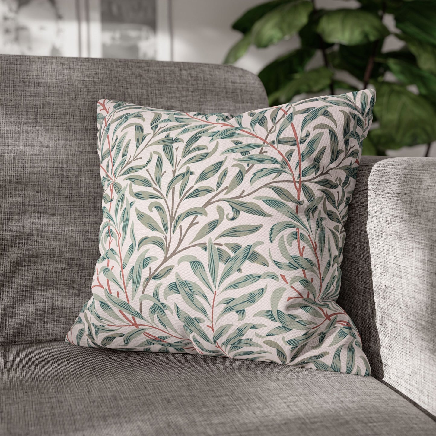 Decorative pillow with leaf pattern on a gray sofa
