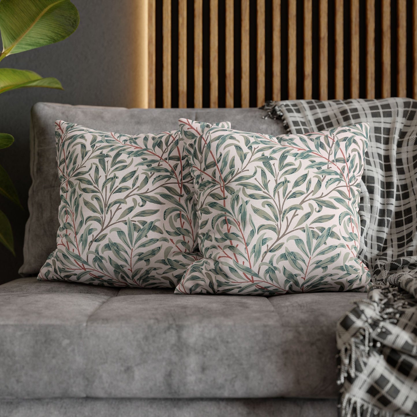 Gray sofa with patterned cushions and a wooden headboard in the background