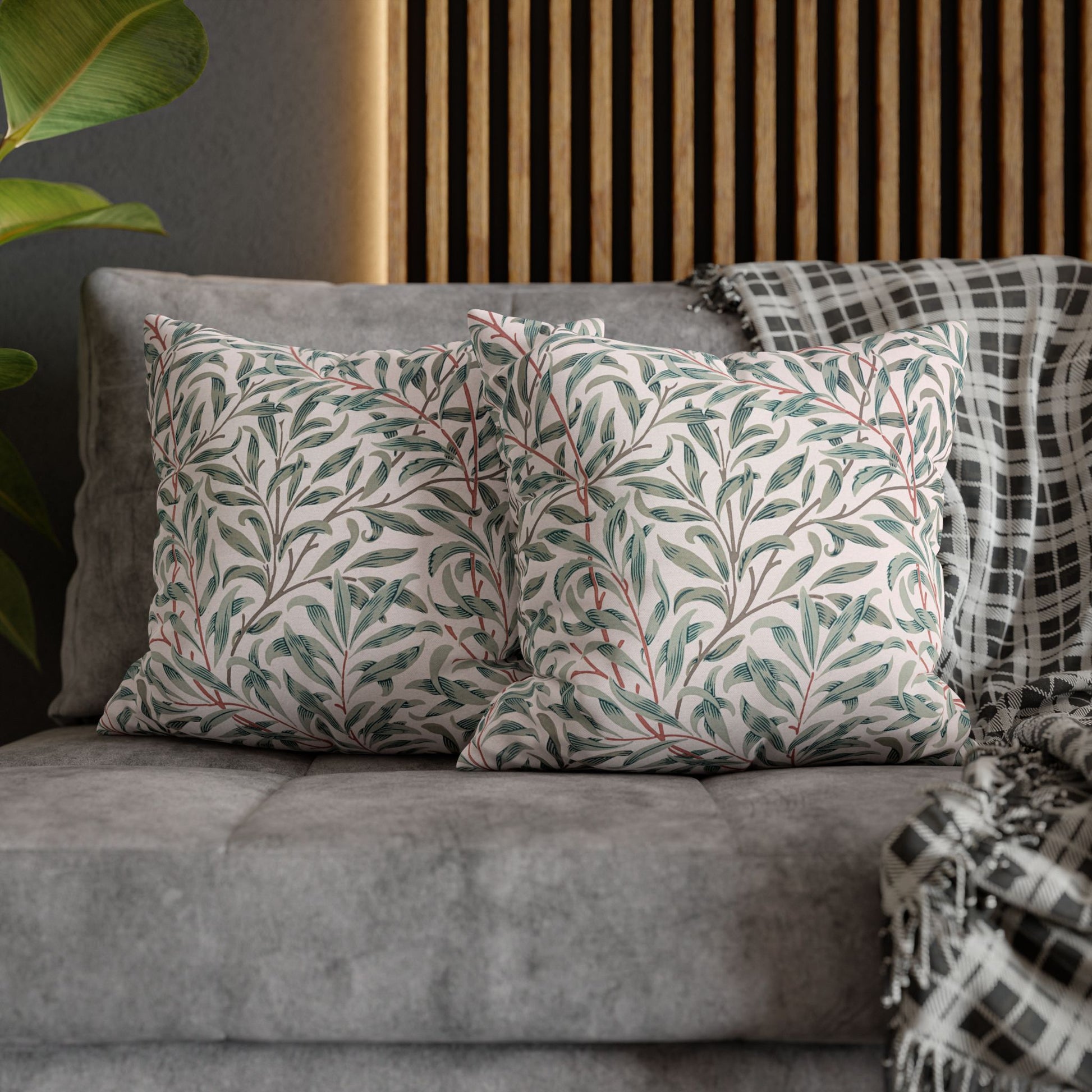 Gray sofa with patterned cushions and a wooden headboard in the background