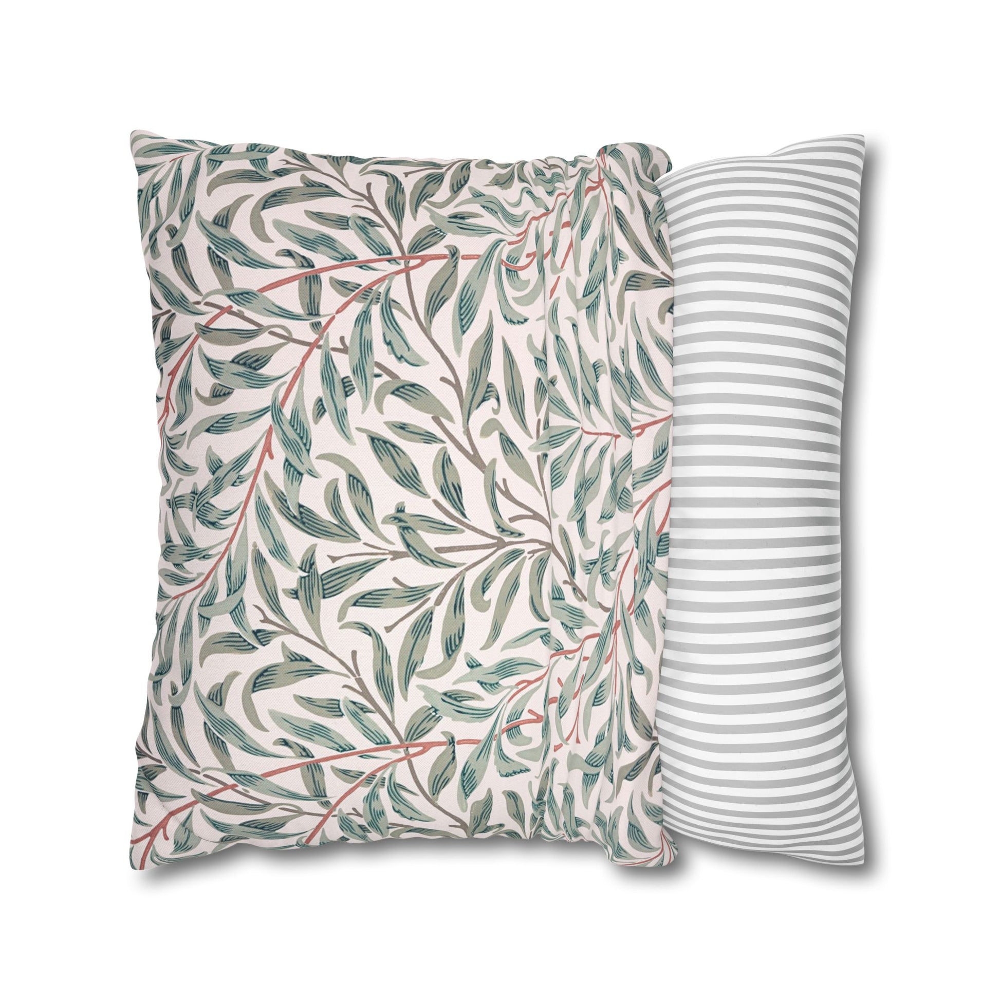 Two pillows with leaf pattern and striped design on a white background