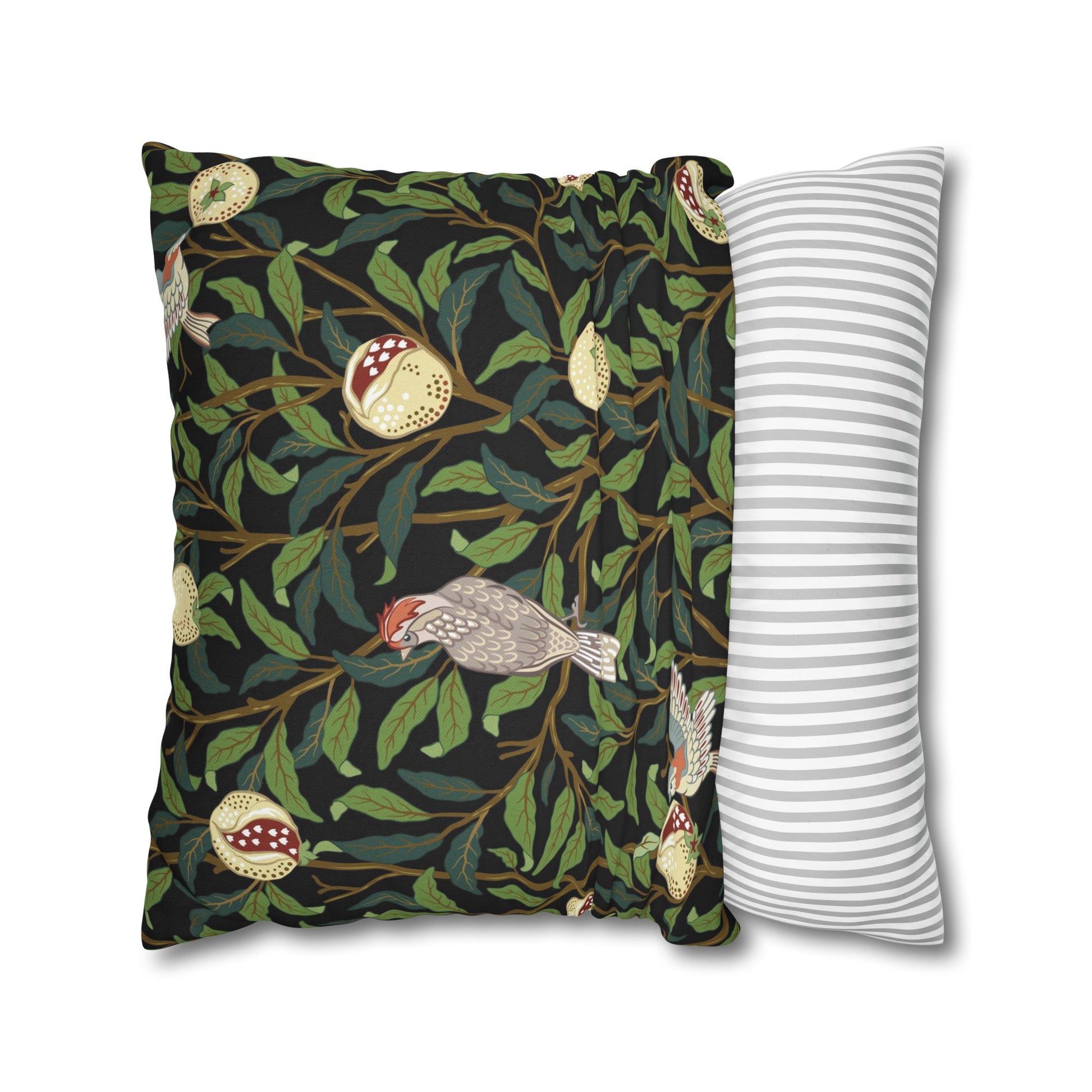 Decorative pillow with nature-themed design and a striped pillow next to it on a white background