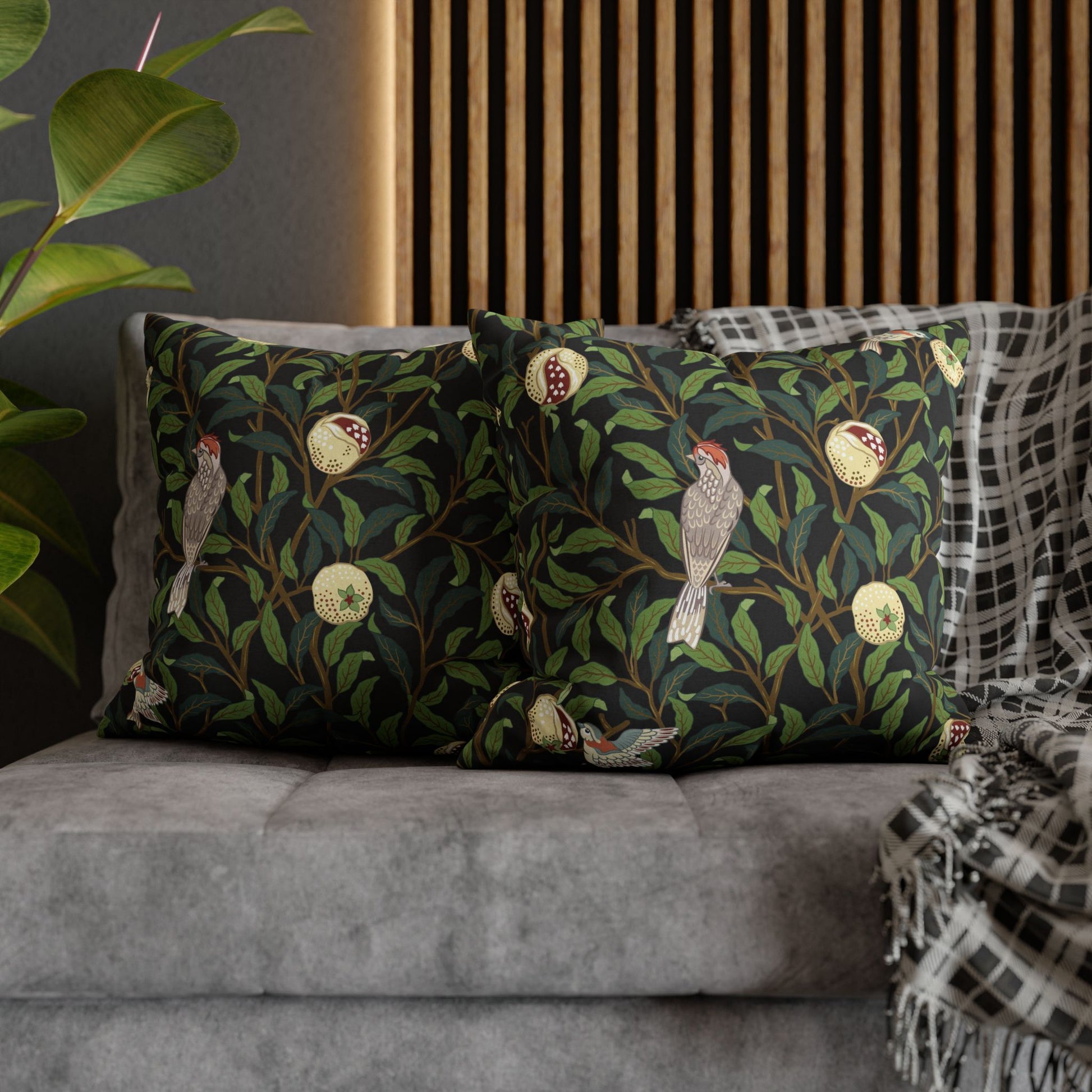 Decorative pillows with nature-themed design on a gray sofa.
