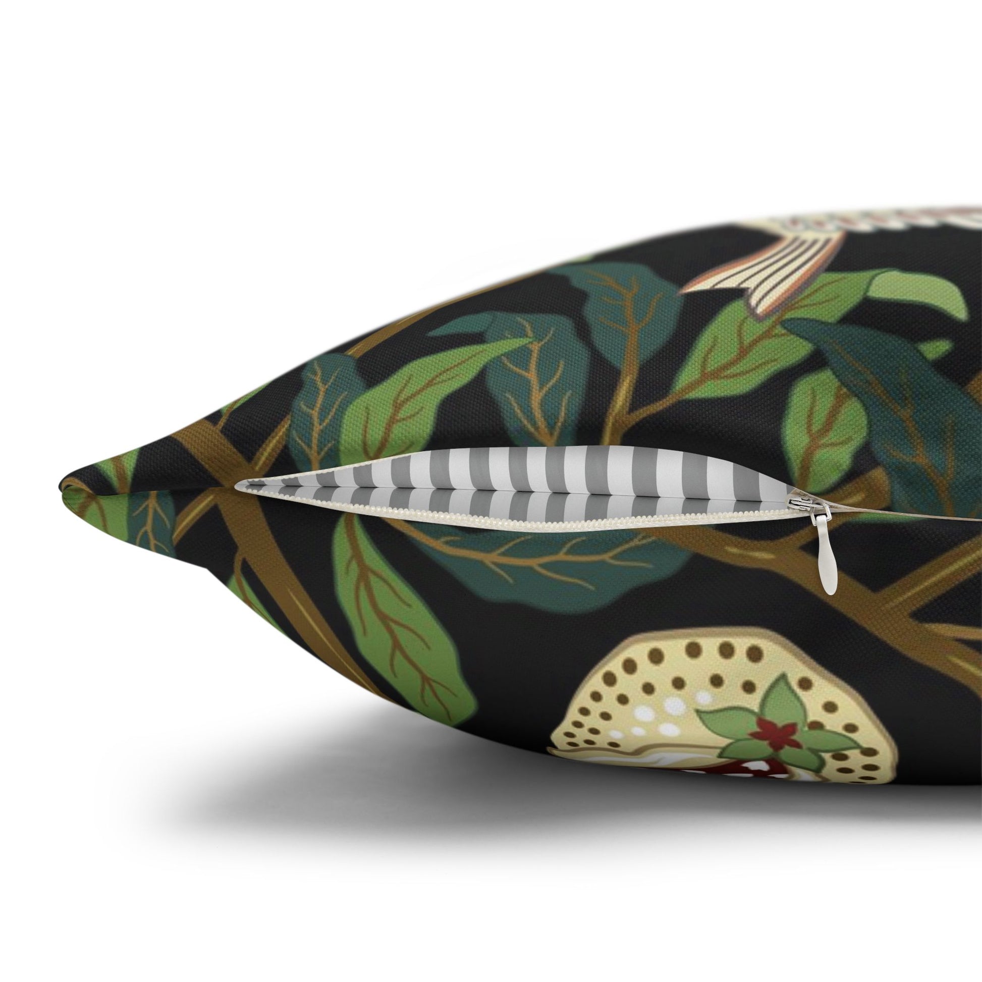 Decorative pillow with leaf pattern and zipper on a white background