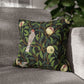 Decorative pillow with bird and apple design on a gray sofa