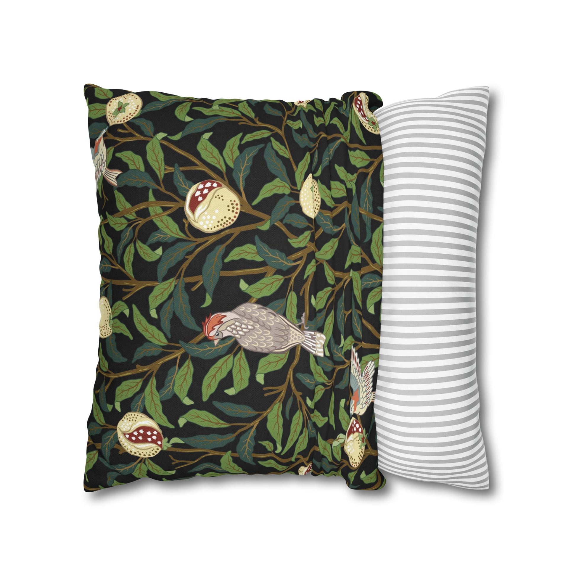 Decorative pillow with nature-themed design and a plain striped pillow on a white background