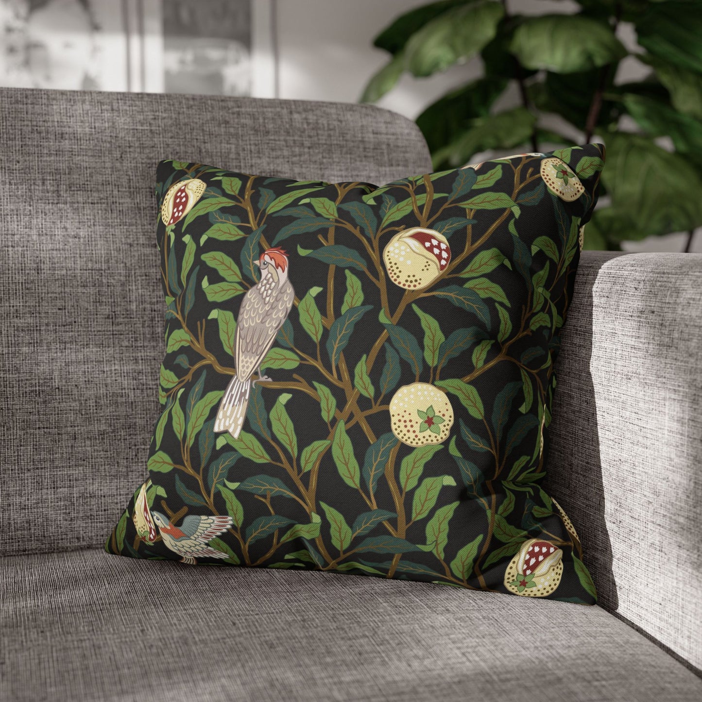 Decorative pillow with nature-themed design on a gray sofa