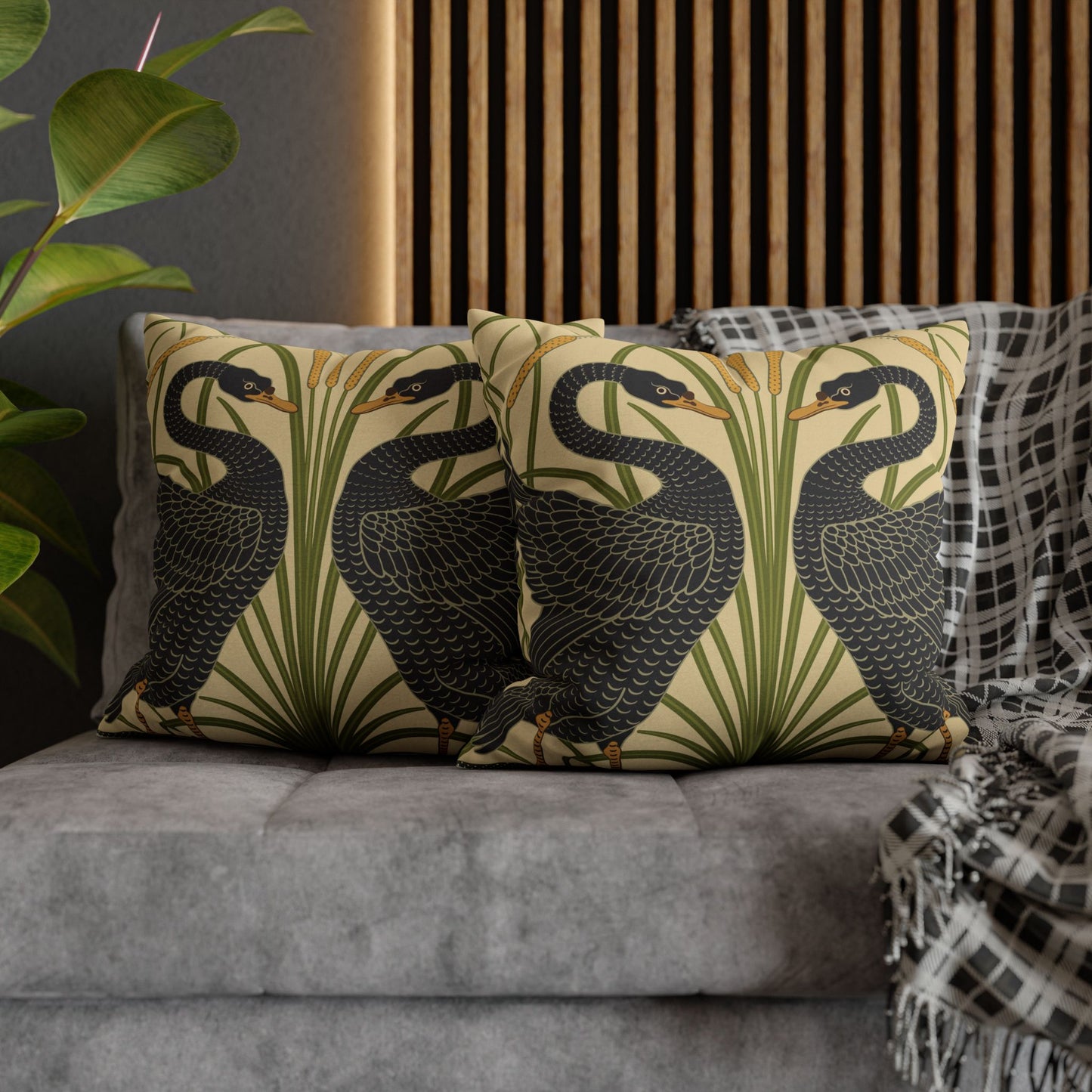 Decorative pillows with bird pattern on a gray sofa