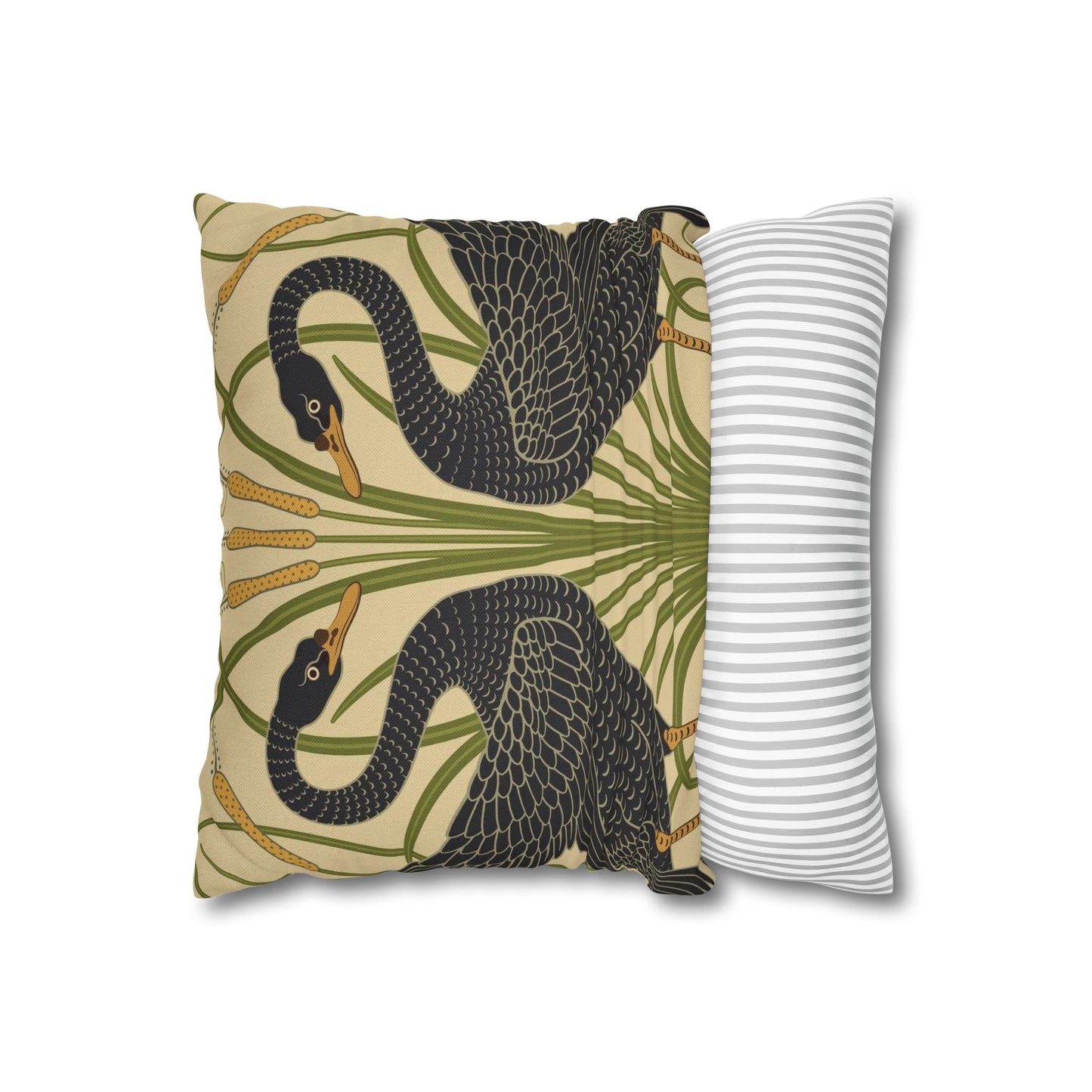 Decorative pillow with snake and palm leaf design next to a plain white pillow on a beige background
