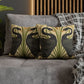 Decorative pillows with bird design on a gray sofa