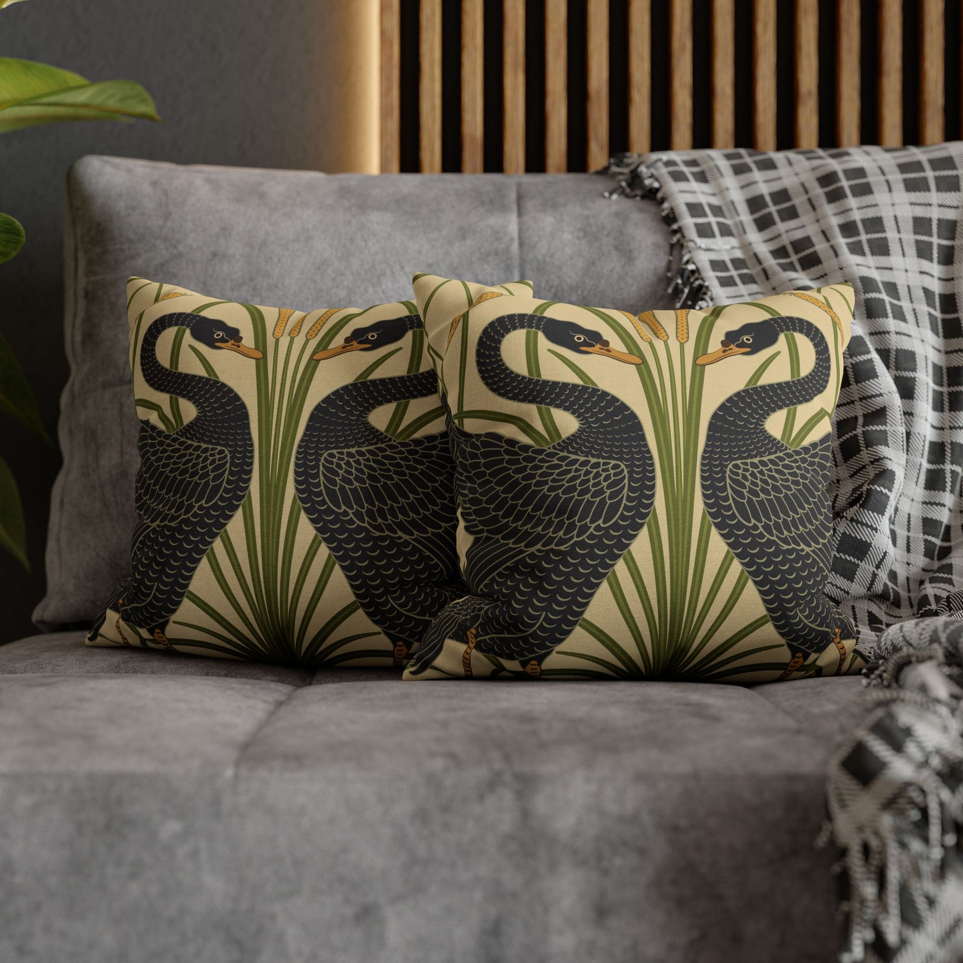 Decorative pillows with bird design on a gray sofa