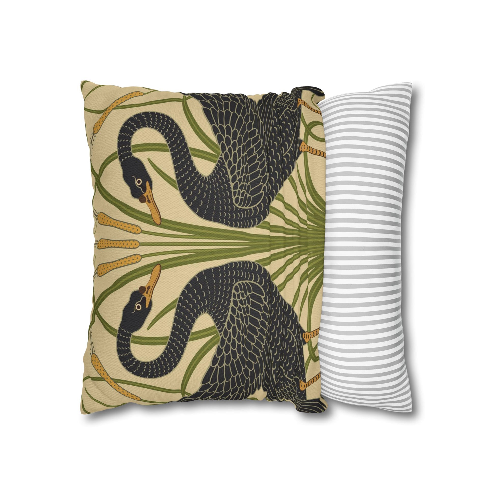 Decorative pillow with snake and palm leaf pattern next to a striped pillow on a white background