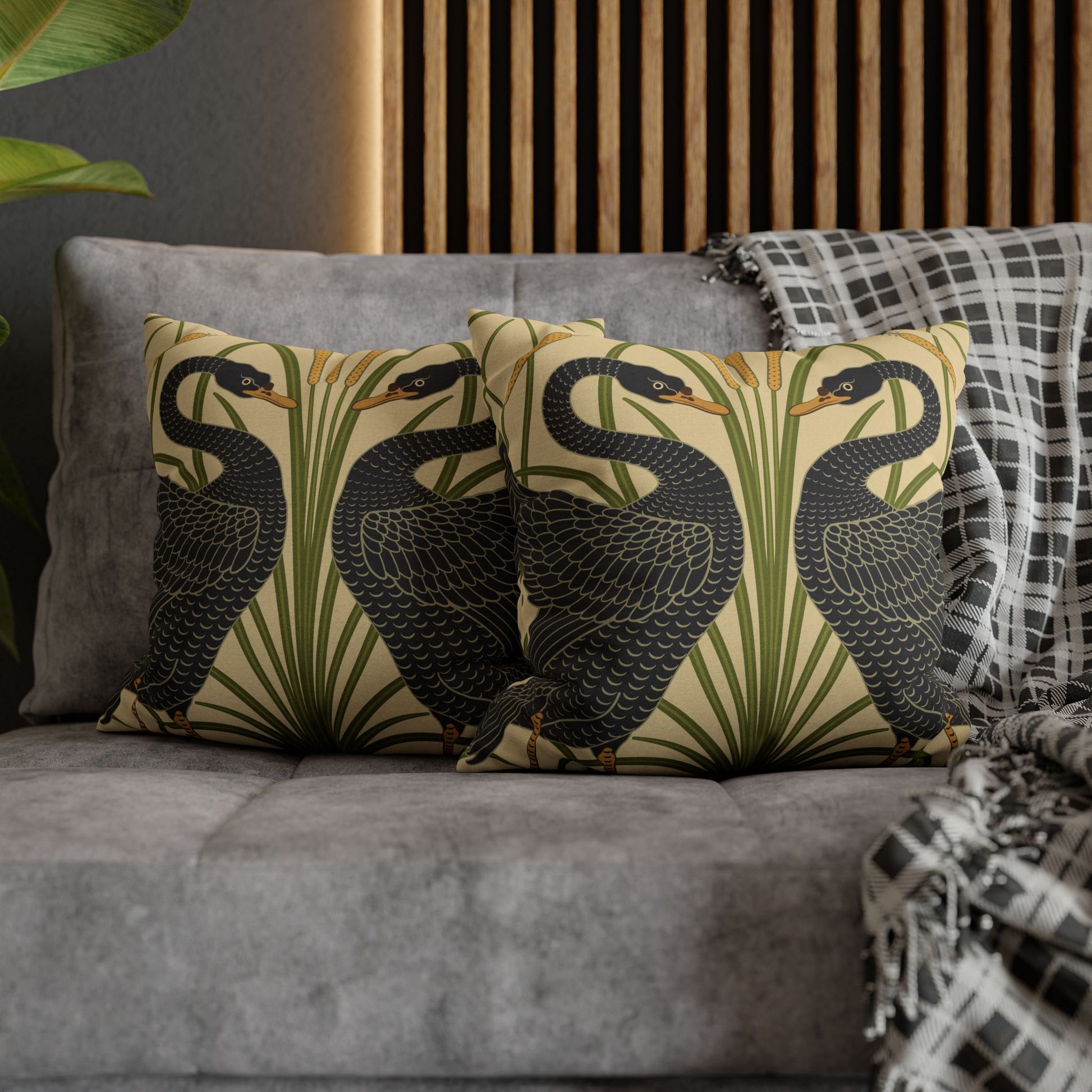 Decorative pillows with bird pattern on a gray sofa