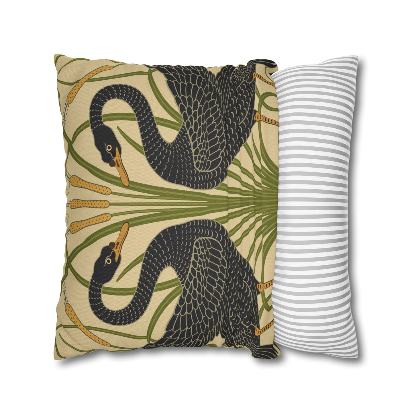Decorative pillow with snake and leaf pattern next to a striped pillow on a white background