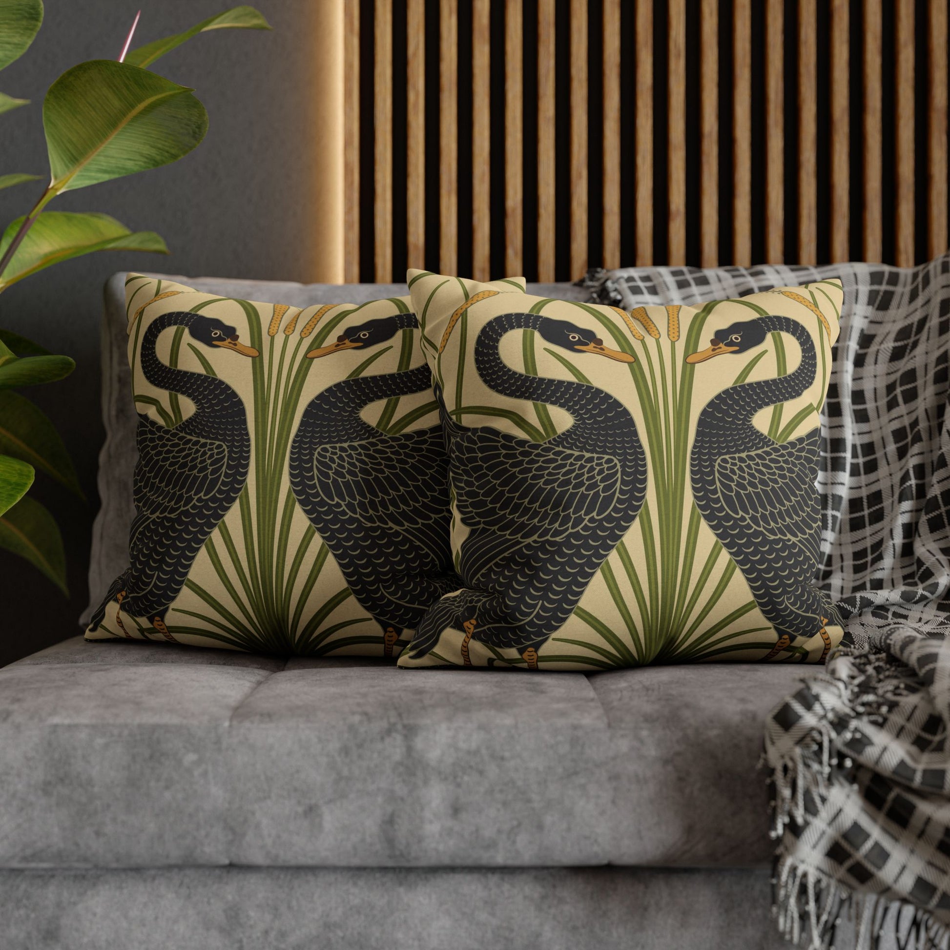 Decorative pillows with bird pattern on a gray sofa