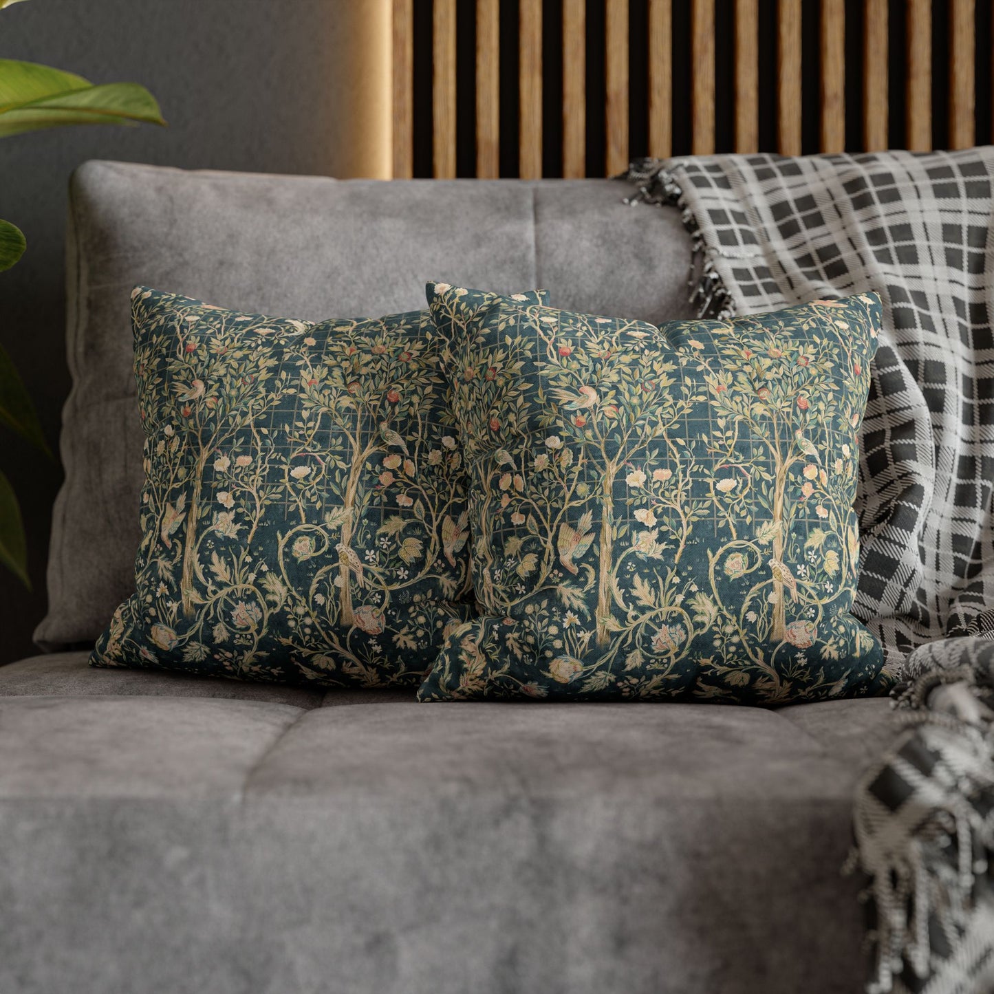 Decorative pillows with floral patterns on a gray sofa.