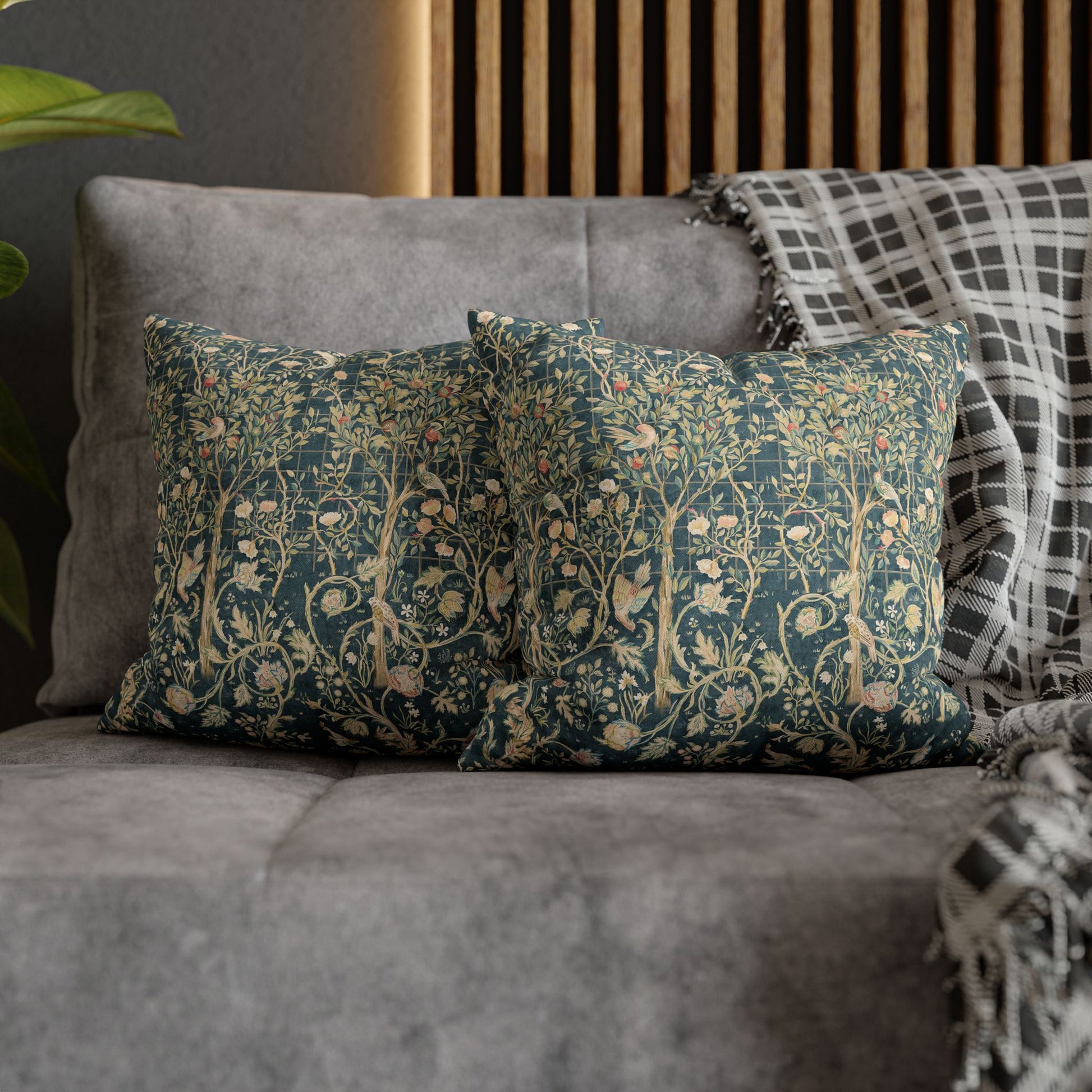 Decorative pillows with floral patterns on a gray sofa.