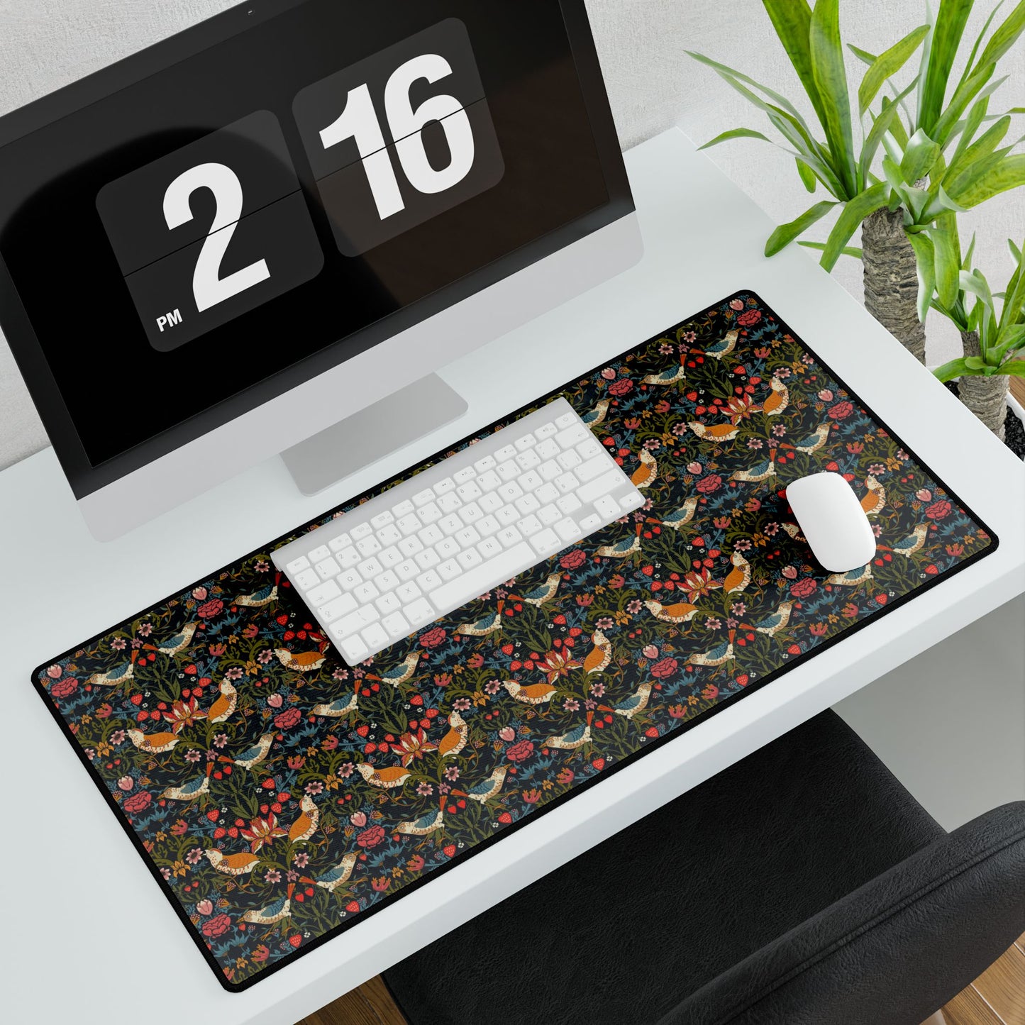 Desk setup with a floral mouse pad featuring roosters.