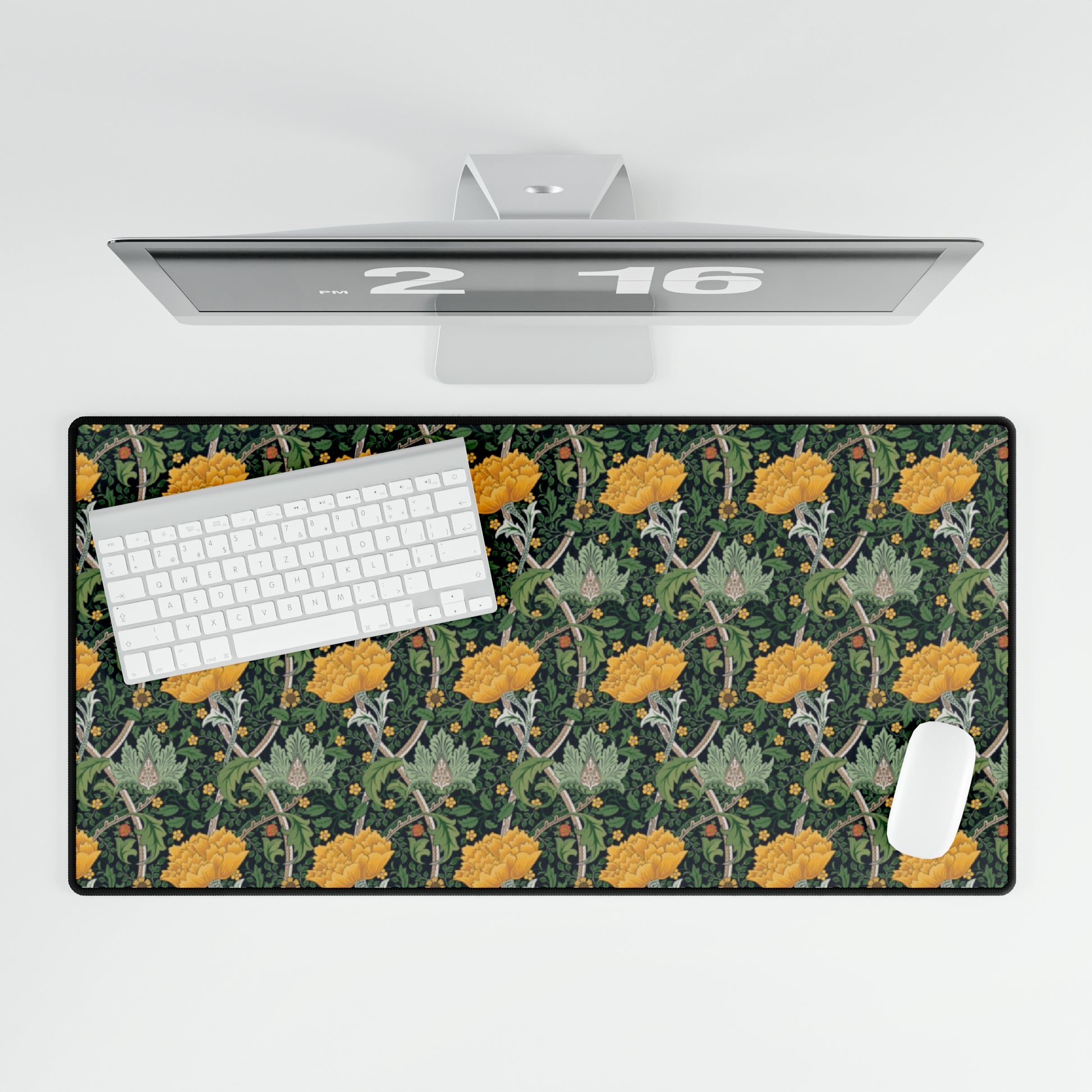 A desk mat with a floral pattern, inspired by William Morris - Chrysanthemum Collection, placed under a desk with a keyboard and mouse on top.