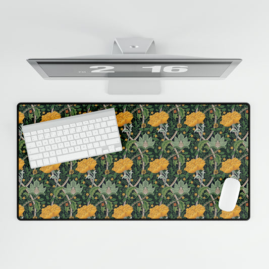 A desk mat with a floral pattern, inspired by William Morris - Chrysanthemum Collection, placed under a desk with a keyboard and mouse on top.