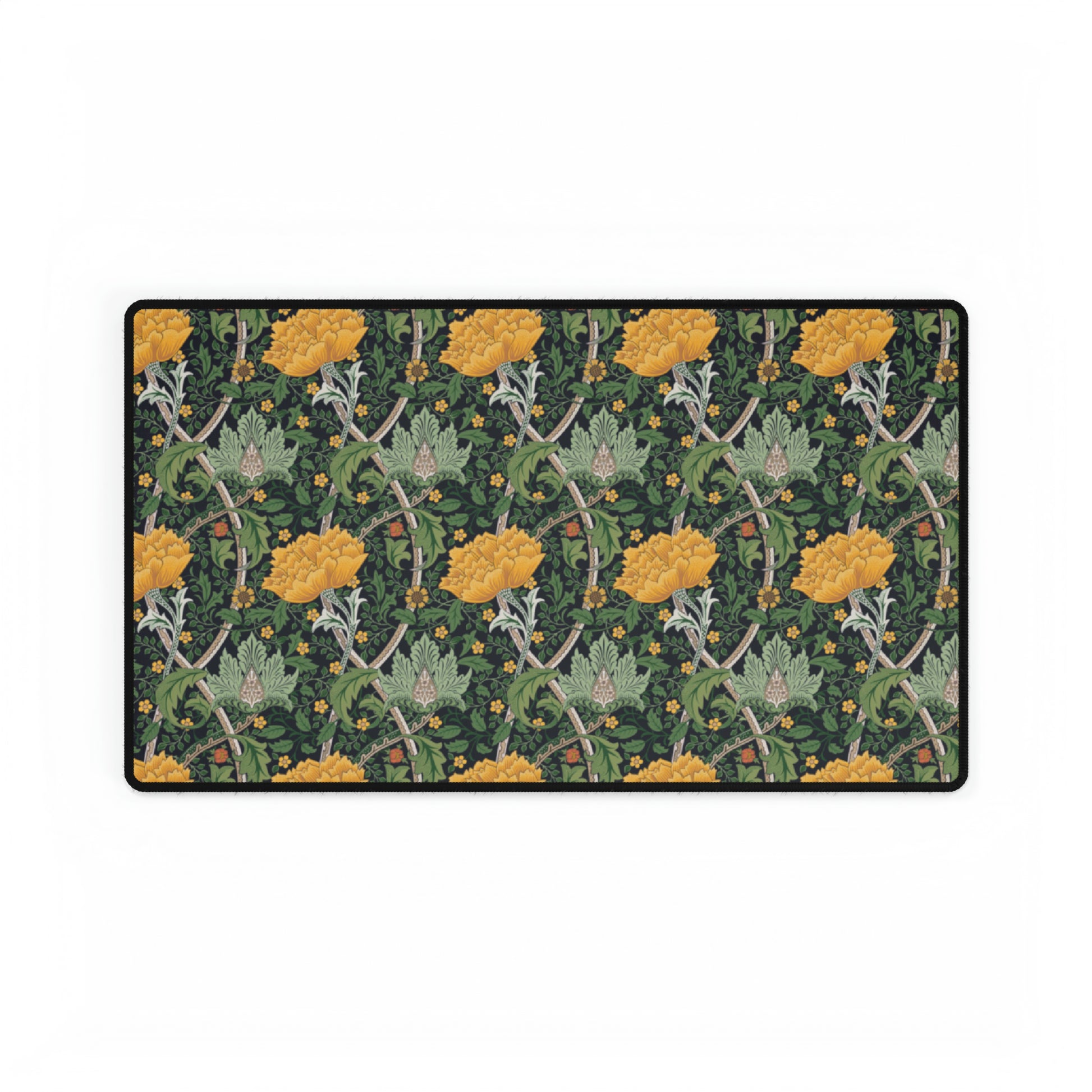 A desk mat with a floral pattern, inspired by William Morris - Chrysanthemum Collection, placed under a desk with a keyboard and mouse on top.