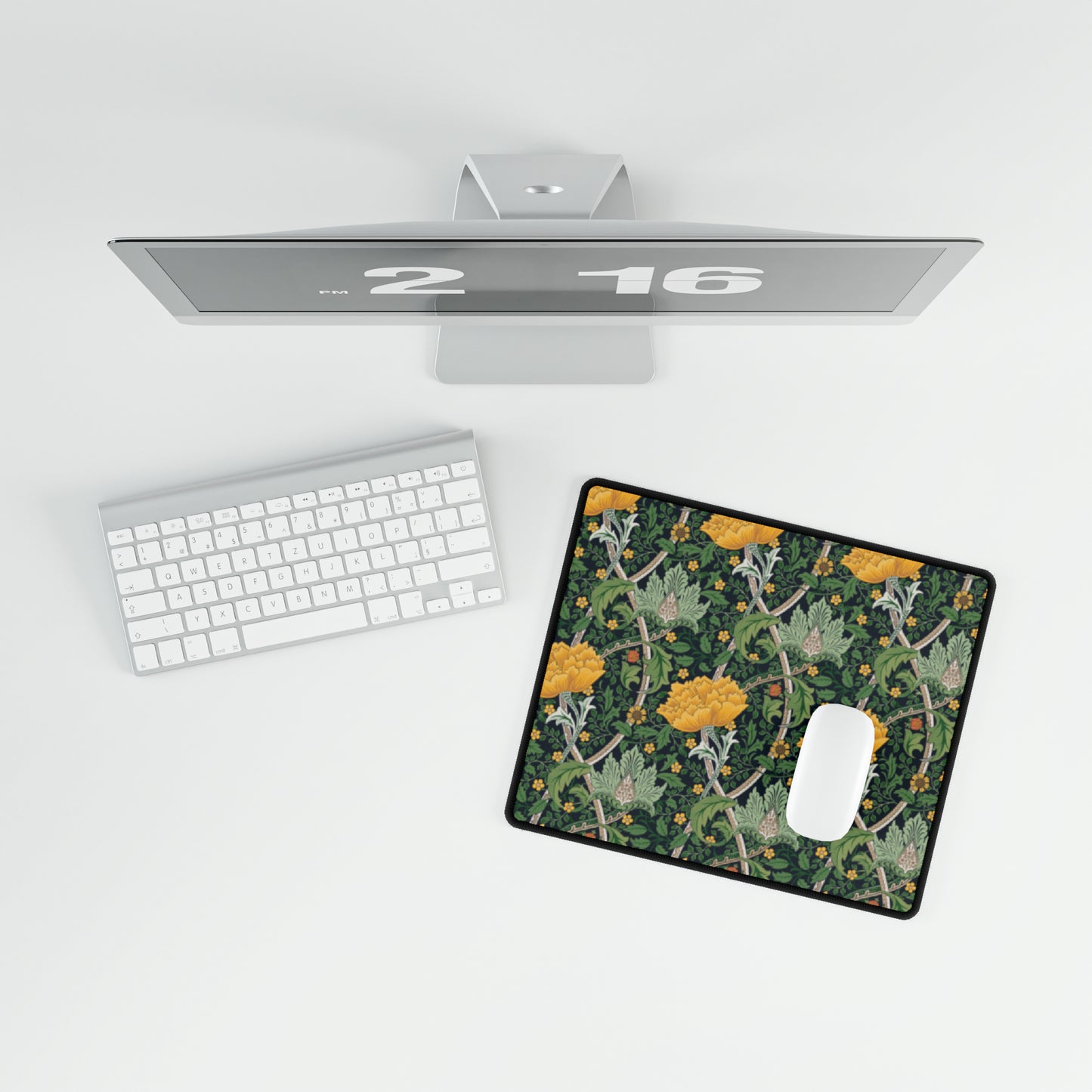A rectangular desk mat with a floral pattern, specifically featuring chrysanthemums, placed on a desk next to a computer monitor, keyboard, and mouse pad.