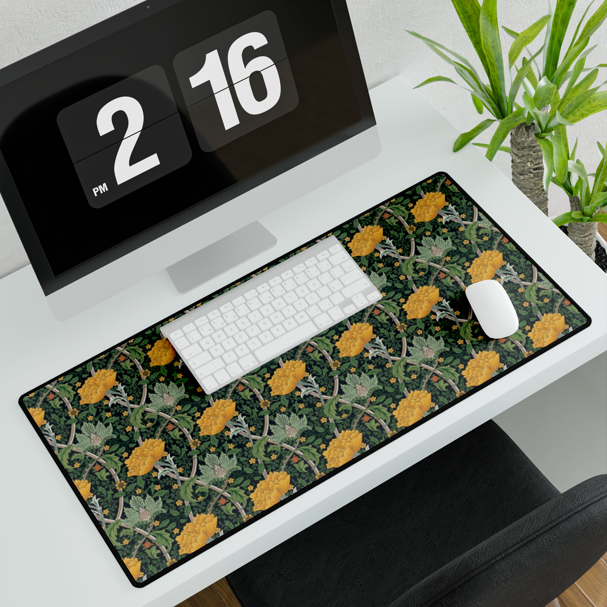 A desk mat with a floral pattern, inspired by William Morris - Chrysanthemum Collection, placed under a desk with a keyboard and mouse on top.
