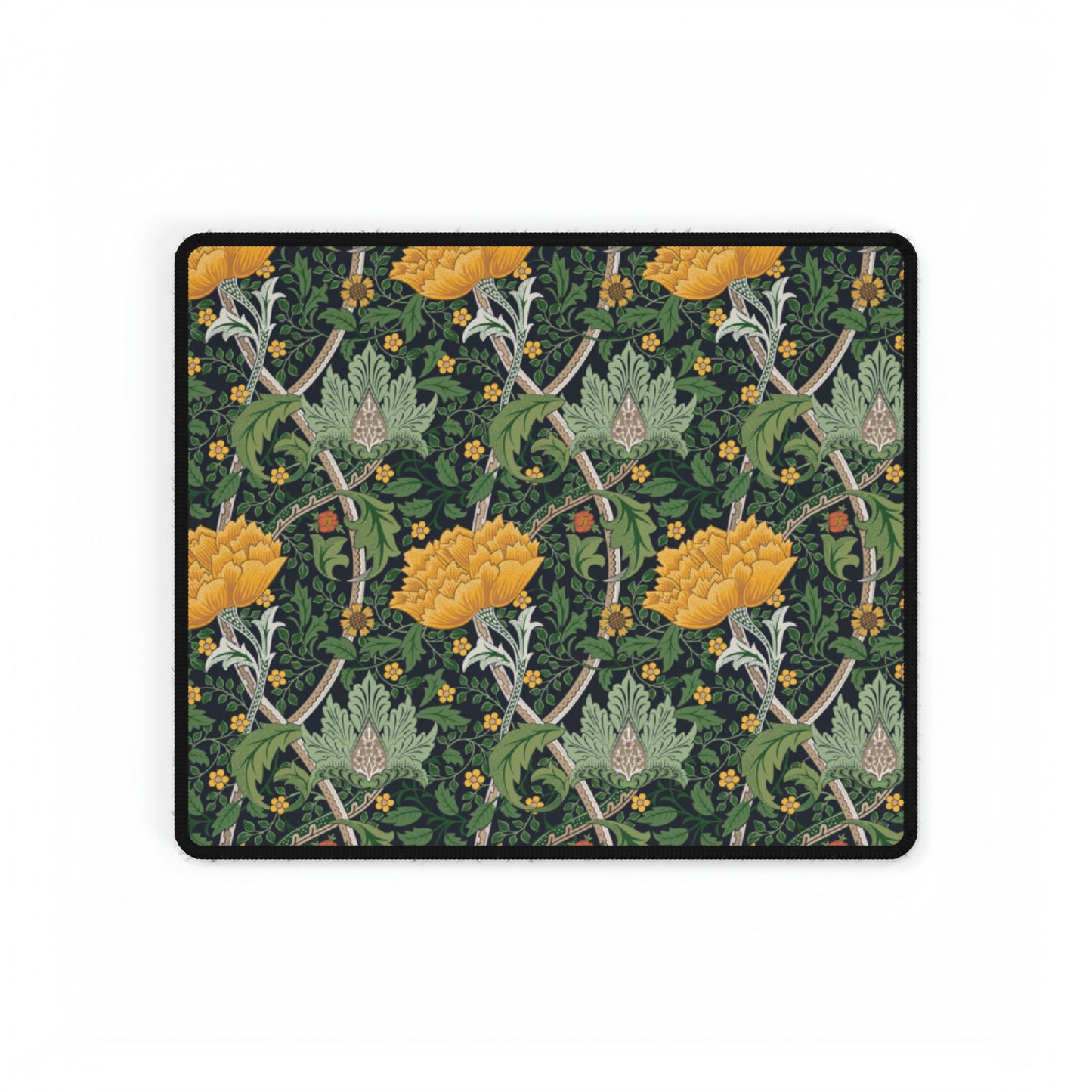 A desk mat with a floral pattern, inspired by William Morris - Chrysanthemum Collection, placed under a desk with a keyboard and mouse on top.