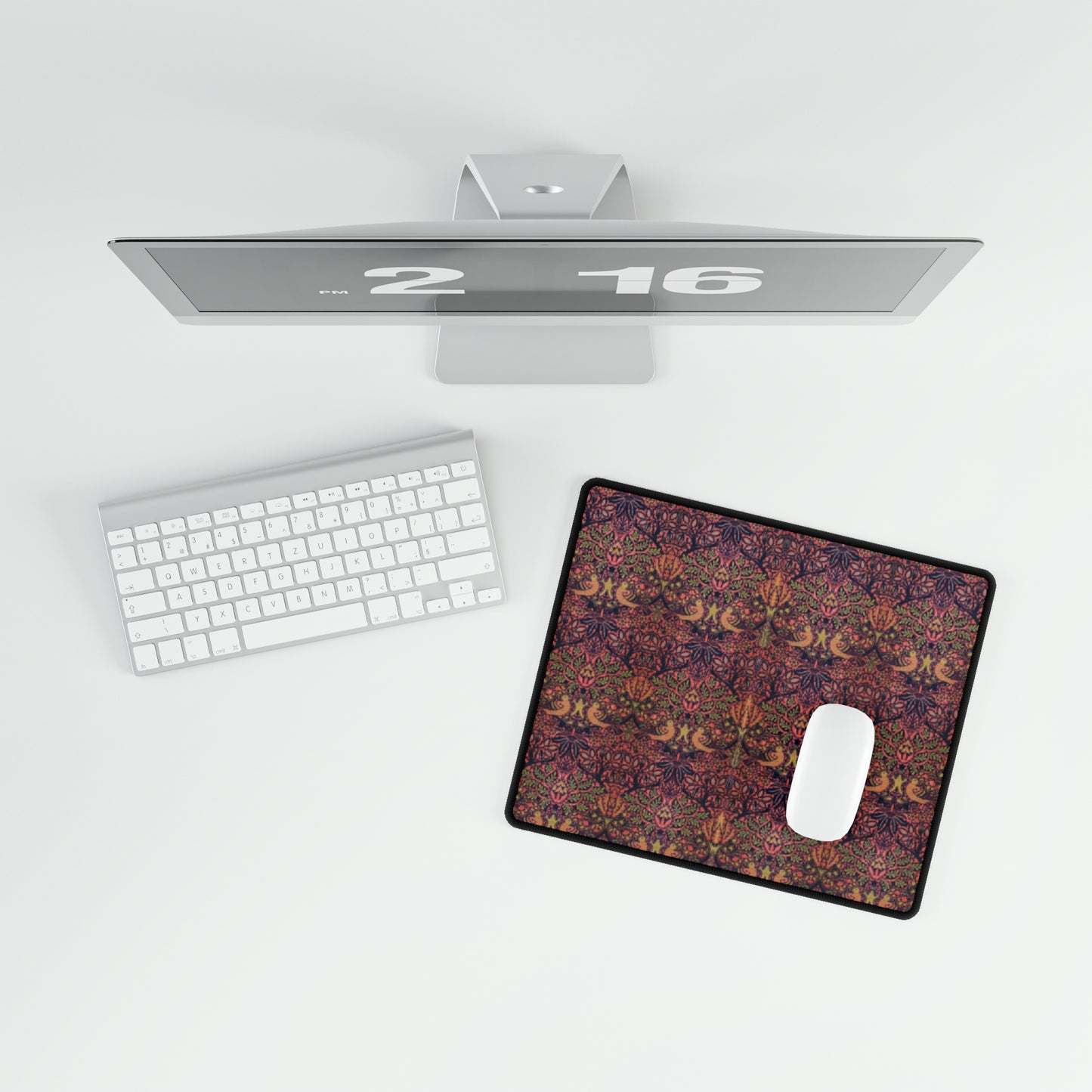 A large desk mat with a floral pattern, displayed on a desk with a keyboard and mouse, with a decorative border.