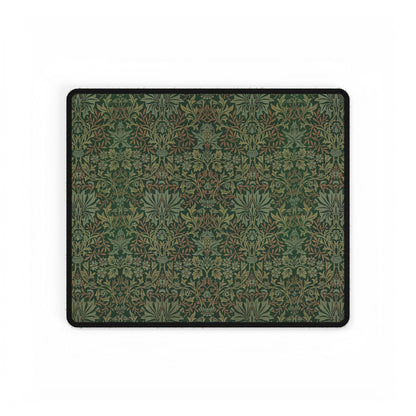 A rectangular desk mat with a floral garden pattern, placed under a desk with a keyboard and mouse on top.