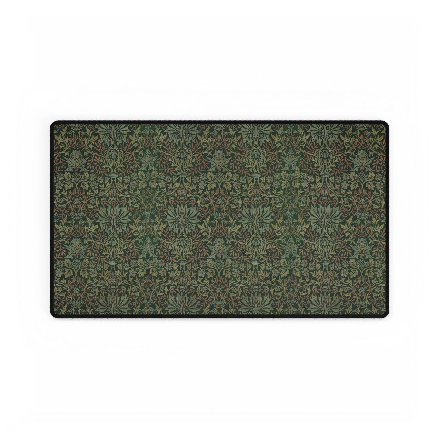 A rectangular desk mat with a floral garden pattern, placed under a desk with a keyboard and mouse on top.