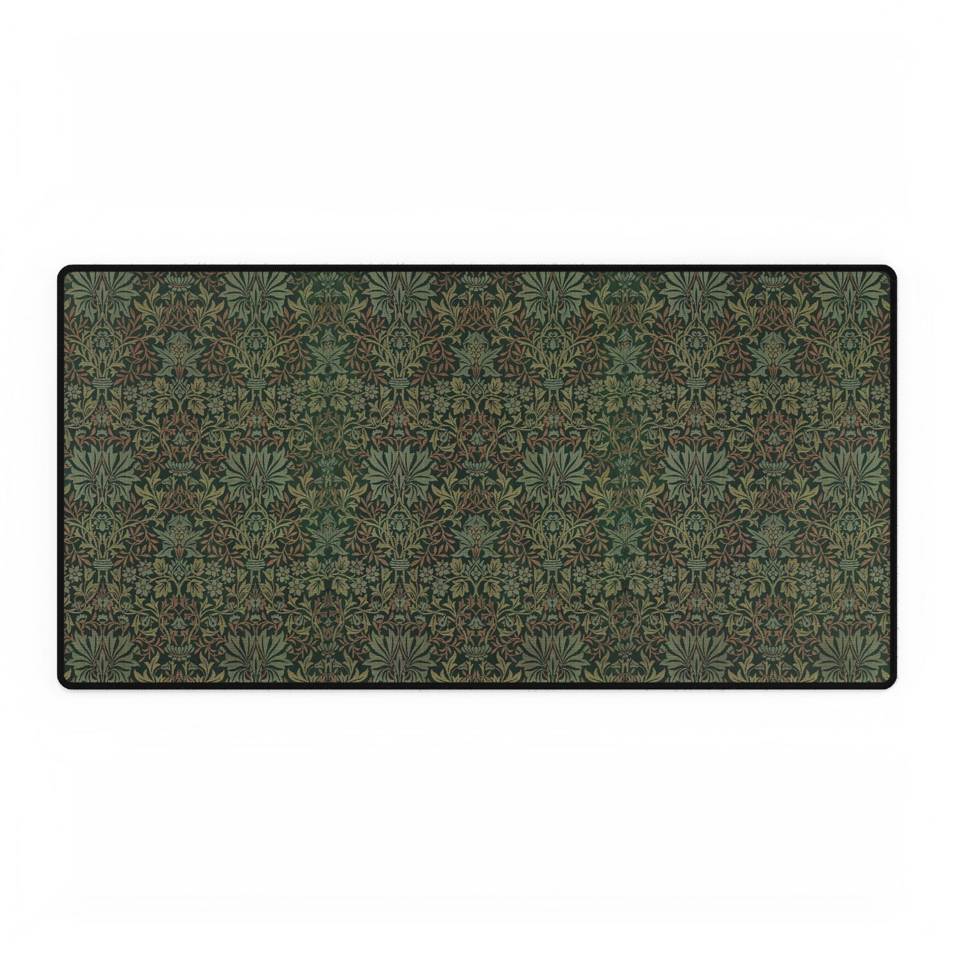 A rectangular desk mat with a floral garden pattern, placed under a desk with a keyboard and mouse on top.