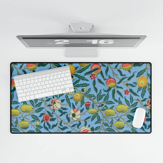 A desk mat with a floral pattern featuring various fruits, placed under a desk with a keyboard and mouse on top.