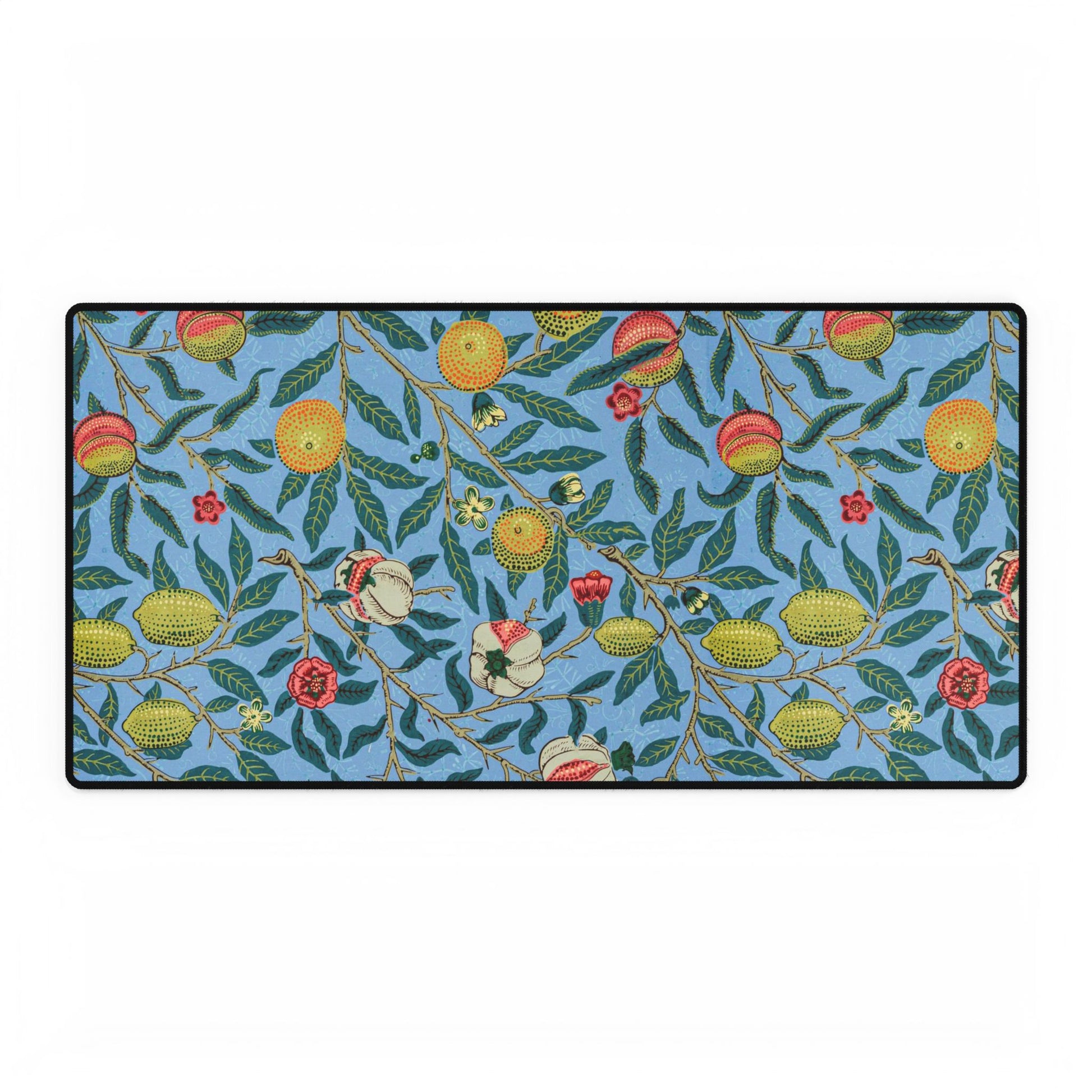 A desk mat with a floral pattern featuring various fruits, placed under a desk with a keyboard and mouse on top.
