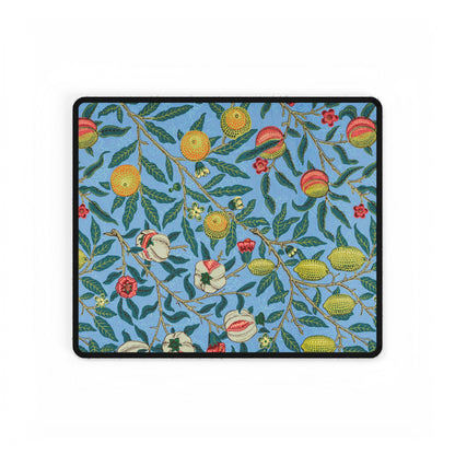 A desk mat with a floral pattern featuring various fruits, placed under a desk with a keyboard and mouse on top.