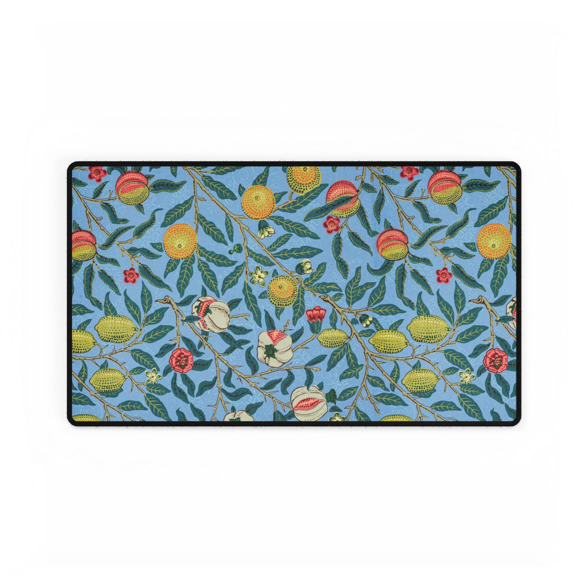 A desk mat with a floral pattern featuring various fruits, placed under a desk with a keyboard and mouse on top.