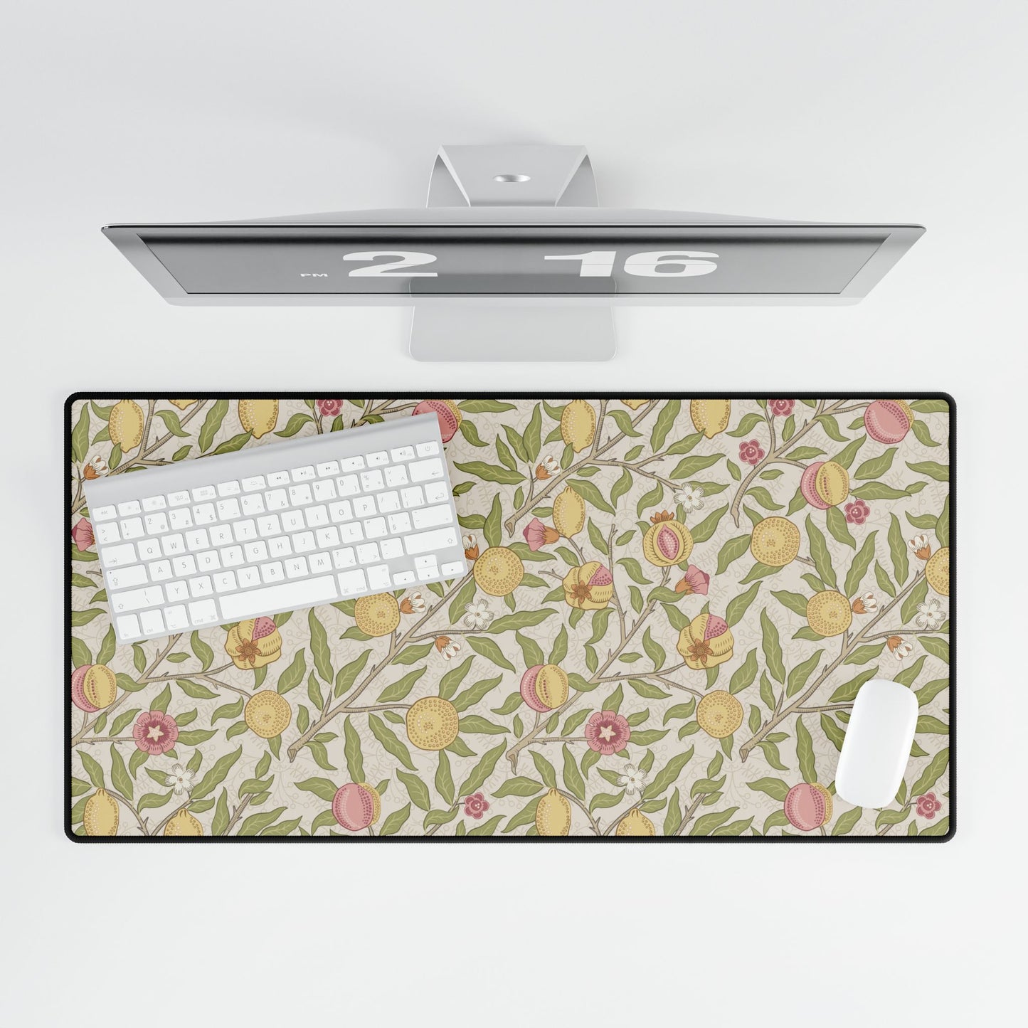 Floral patterned desk mat with a computer setup on a white background