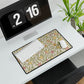 Floral patterned mouse pad on a desk with a computer and digital clock.