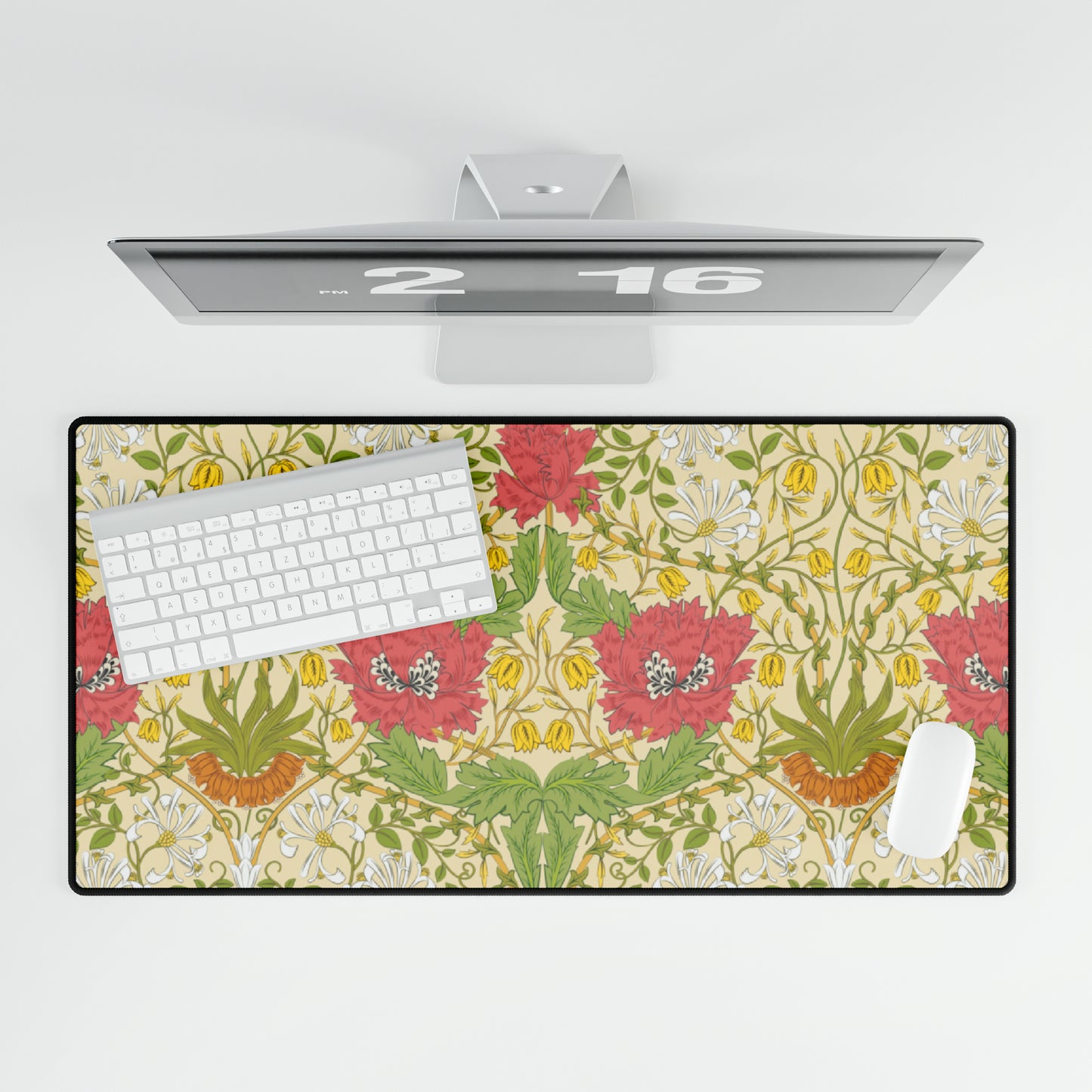 A desk mat with a floral pattern, specifically the Honeysuckle Collection from William Morris & Co, displayed under a mouse and keyboard.
