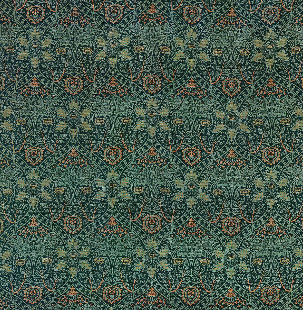 A rectangular desk mat with a William Morris & Co floral pattern in green, brown, and white, placed under a white desk and a keyboard.
