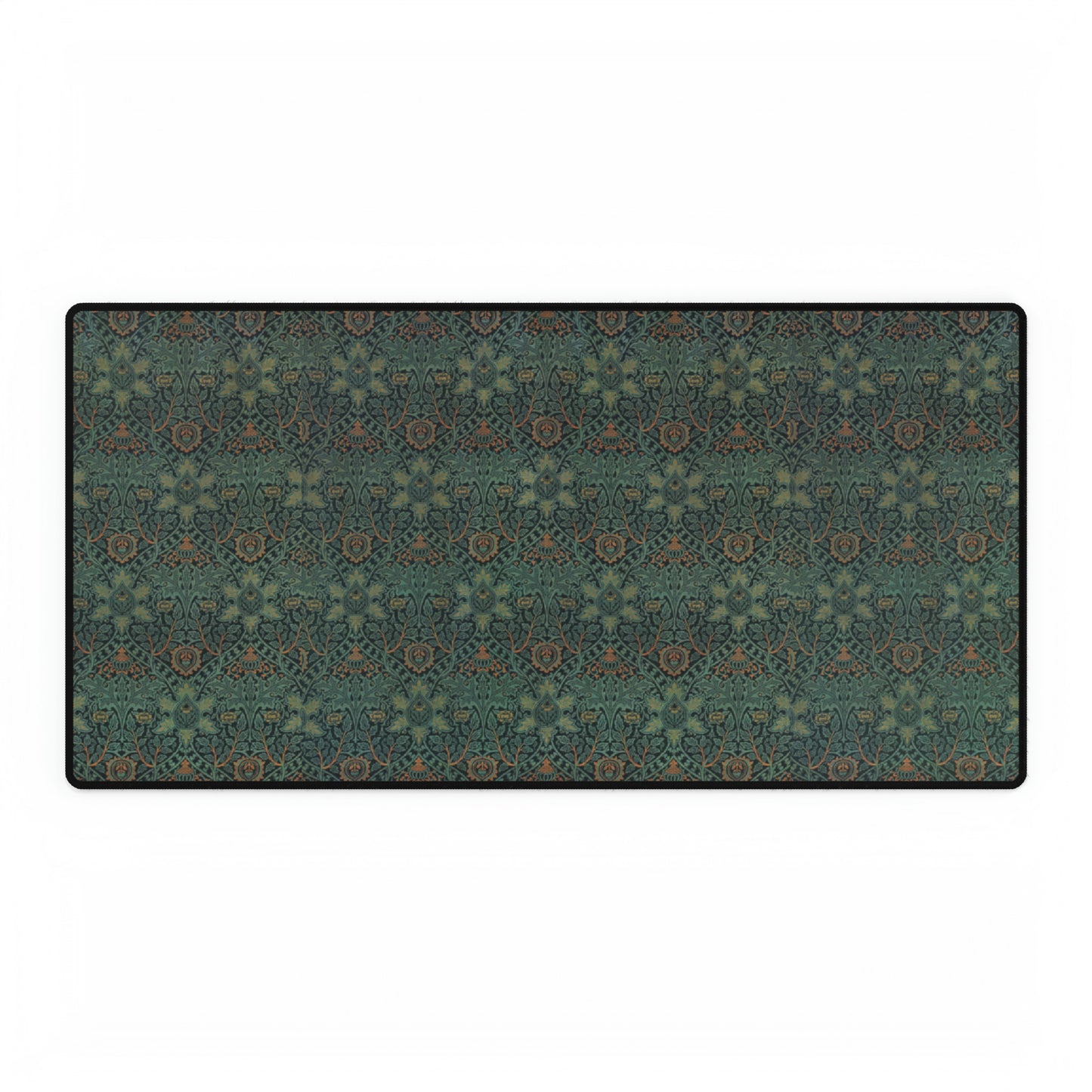 A rectangular desk mat with a William Morris & Co floral pattern in green, brown, and white, placed under a white desk and a keyboard.